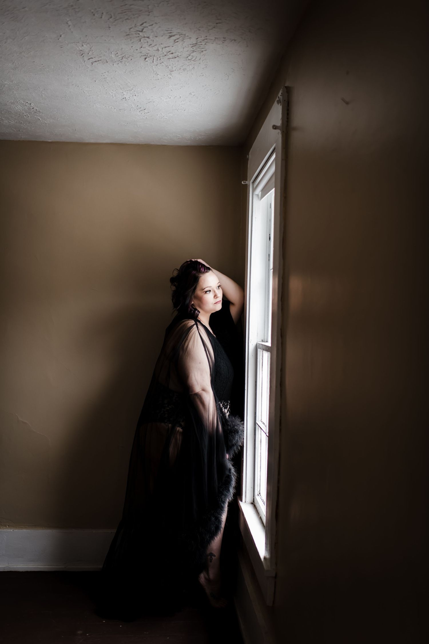 Dramatic silhouette by window with moody natural lighting. Vanceburg Ky