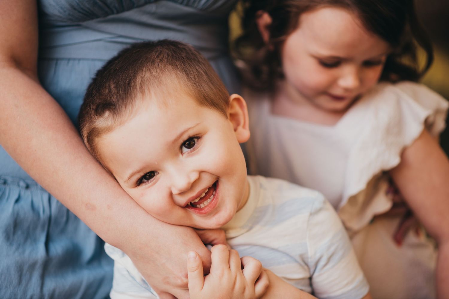 A collection of candid family photos showing joyful expressions and tender moments between parents and children.