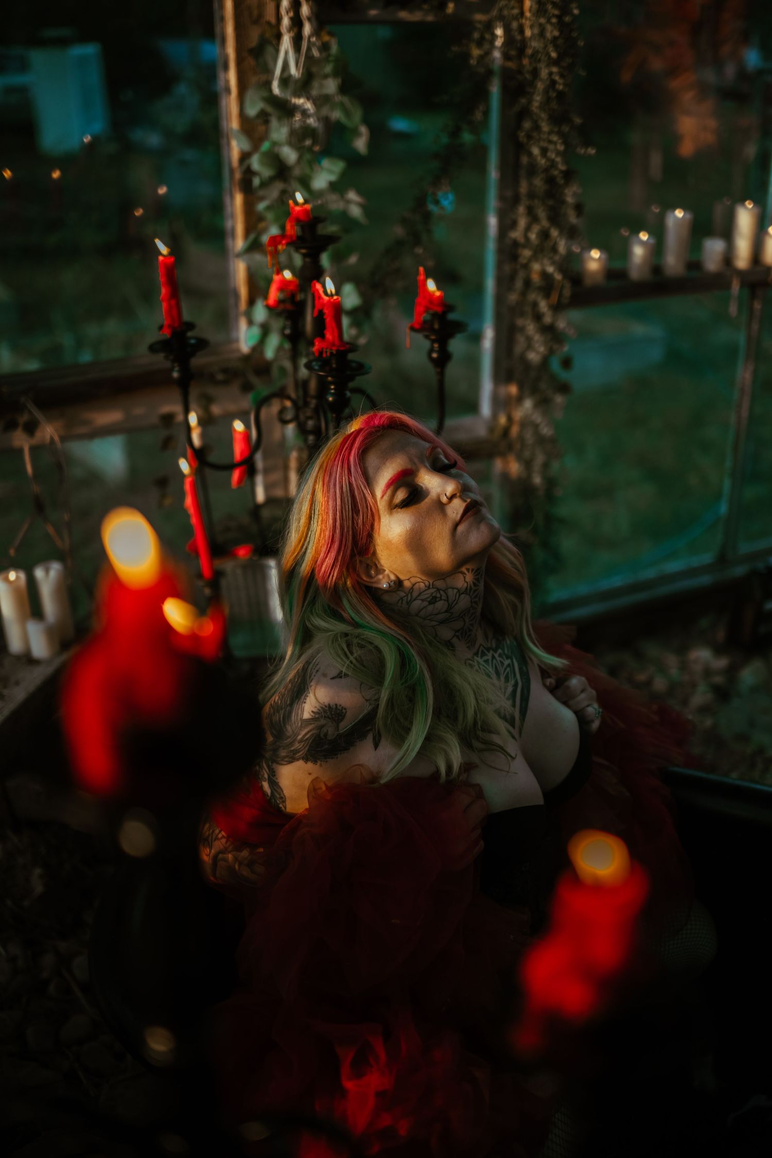 Moody outdoor portrait series with red lights and bokeh effects creating a dark, atmospheric ambiance in nature. Vanceburg Ky
