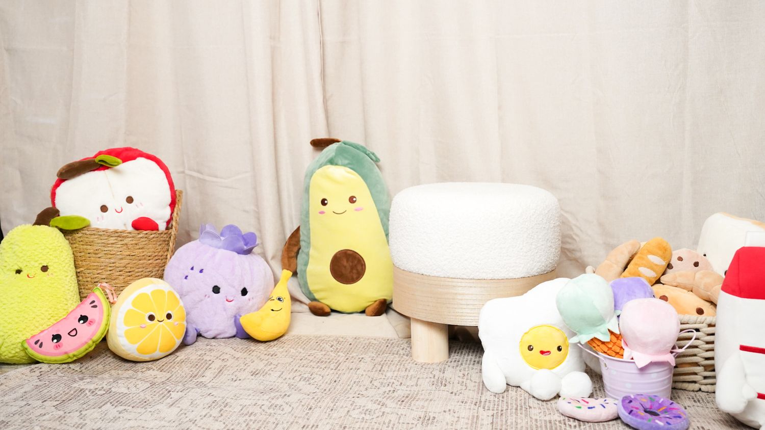 Colorful food-themed plush toys including avocado, watermelon, and fruit characters arranged around a white humidifier.