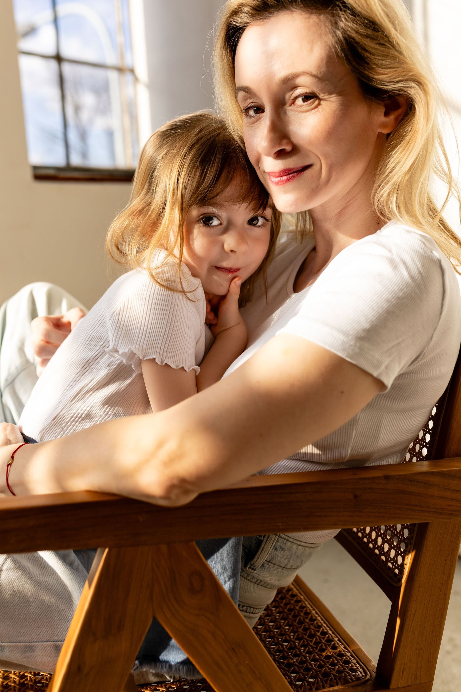 A series of five connected photos showing tender moments between parent and child in warm natural lighting.