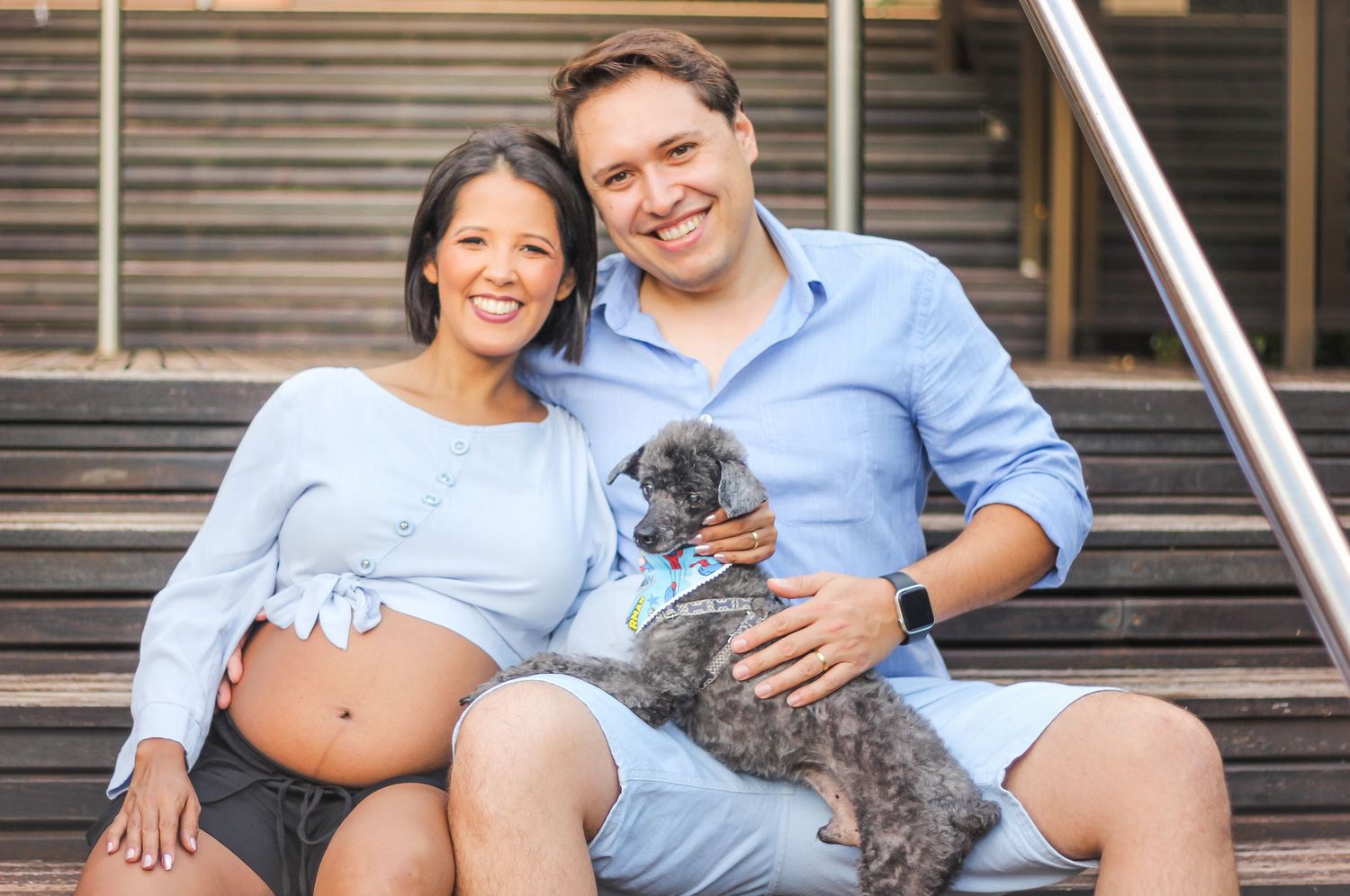 Casual maternity session on wooden steps featuring relaxed poses and natural moments.