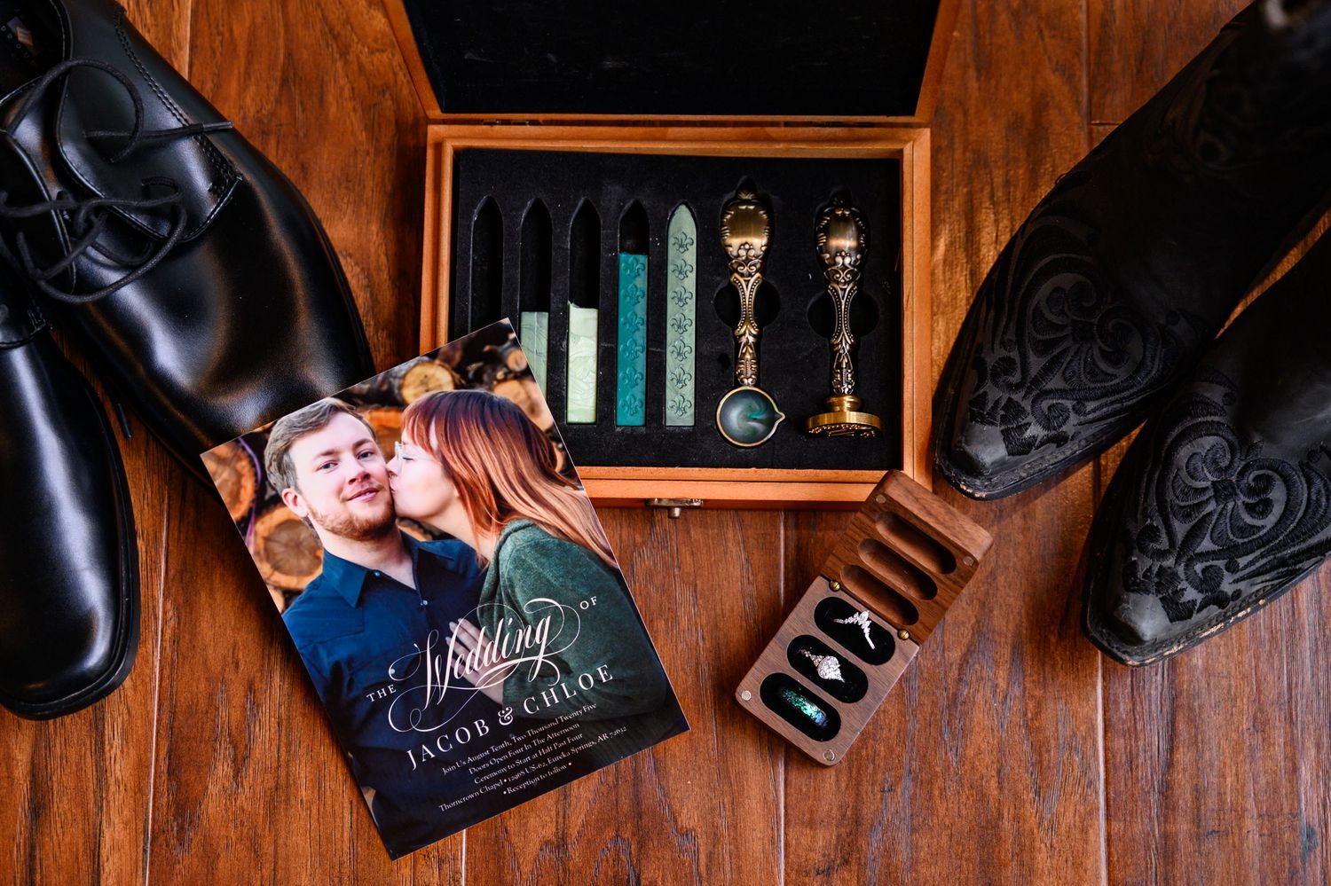 A wedding flat lay of shoes, announcement, rings, and a stamping kit for a wedding in Arkansas.