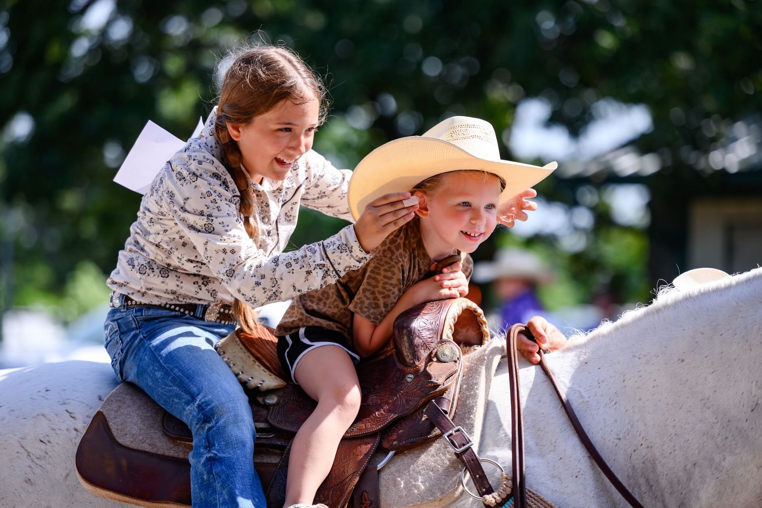 Two girls are having fun on their horse at the Labette County Fair.