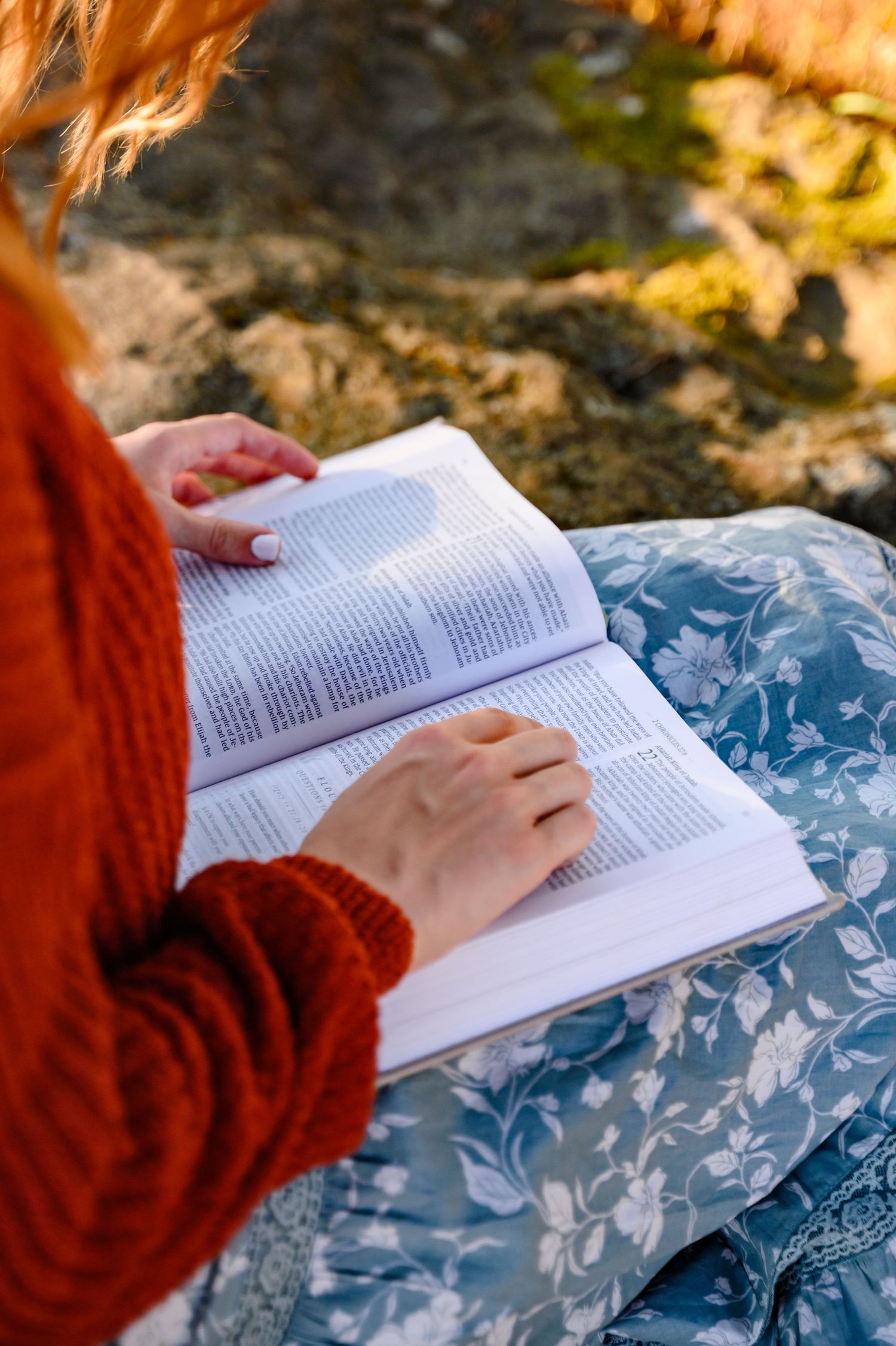 A senior girl shows her true personality, showing her bible during her senior photos.