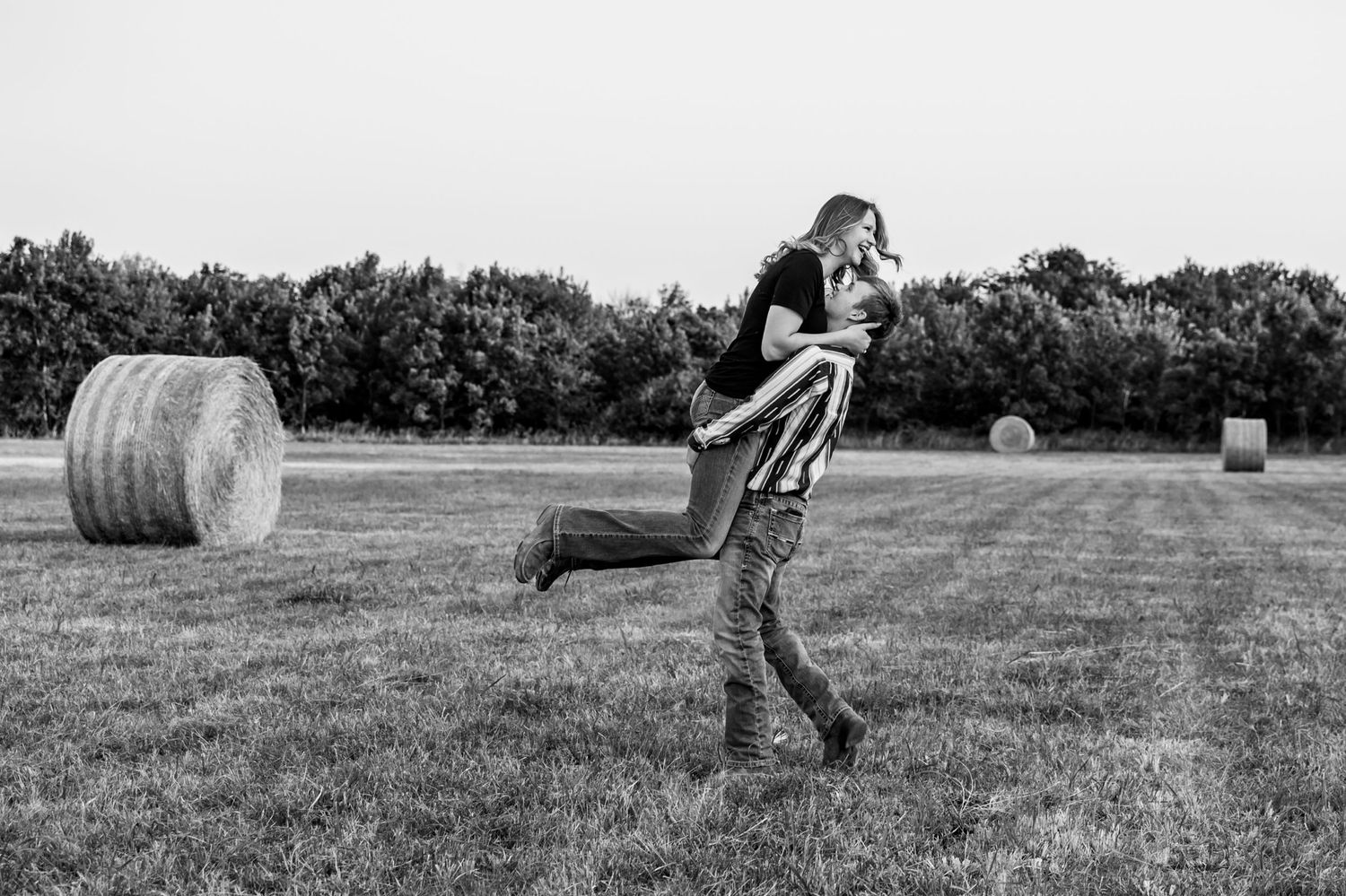 A couple having fun in a hayfield.