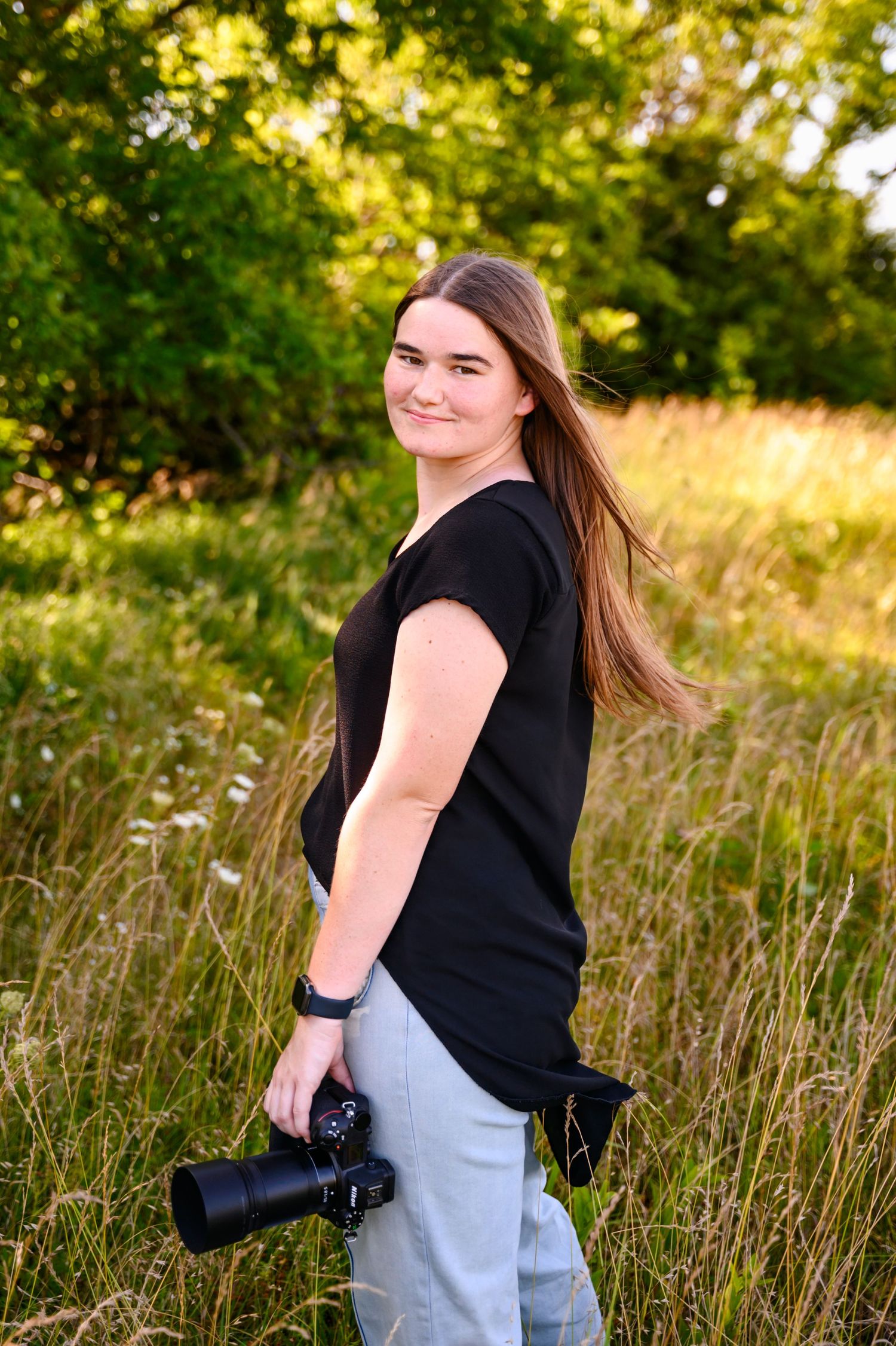 Photographer Amber Ross is holding her camera in a client favorite location.