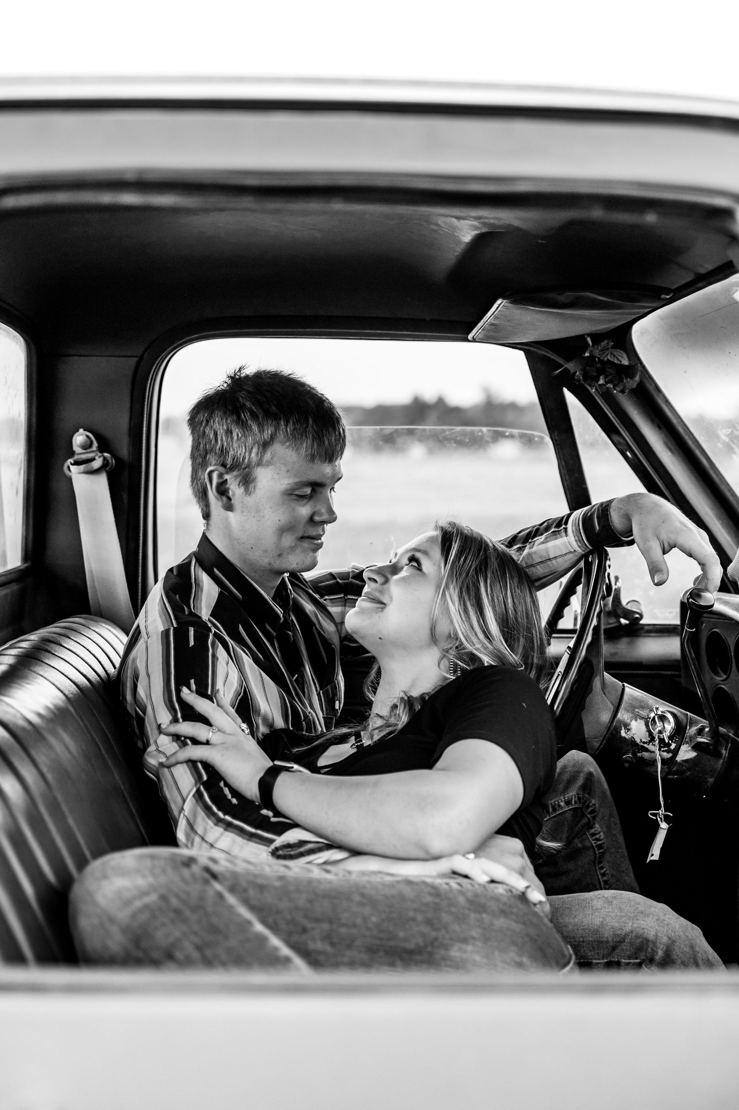 Black and white photo sequence showing two people in a car sharing an intimate moment in five progressive frames.