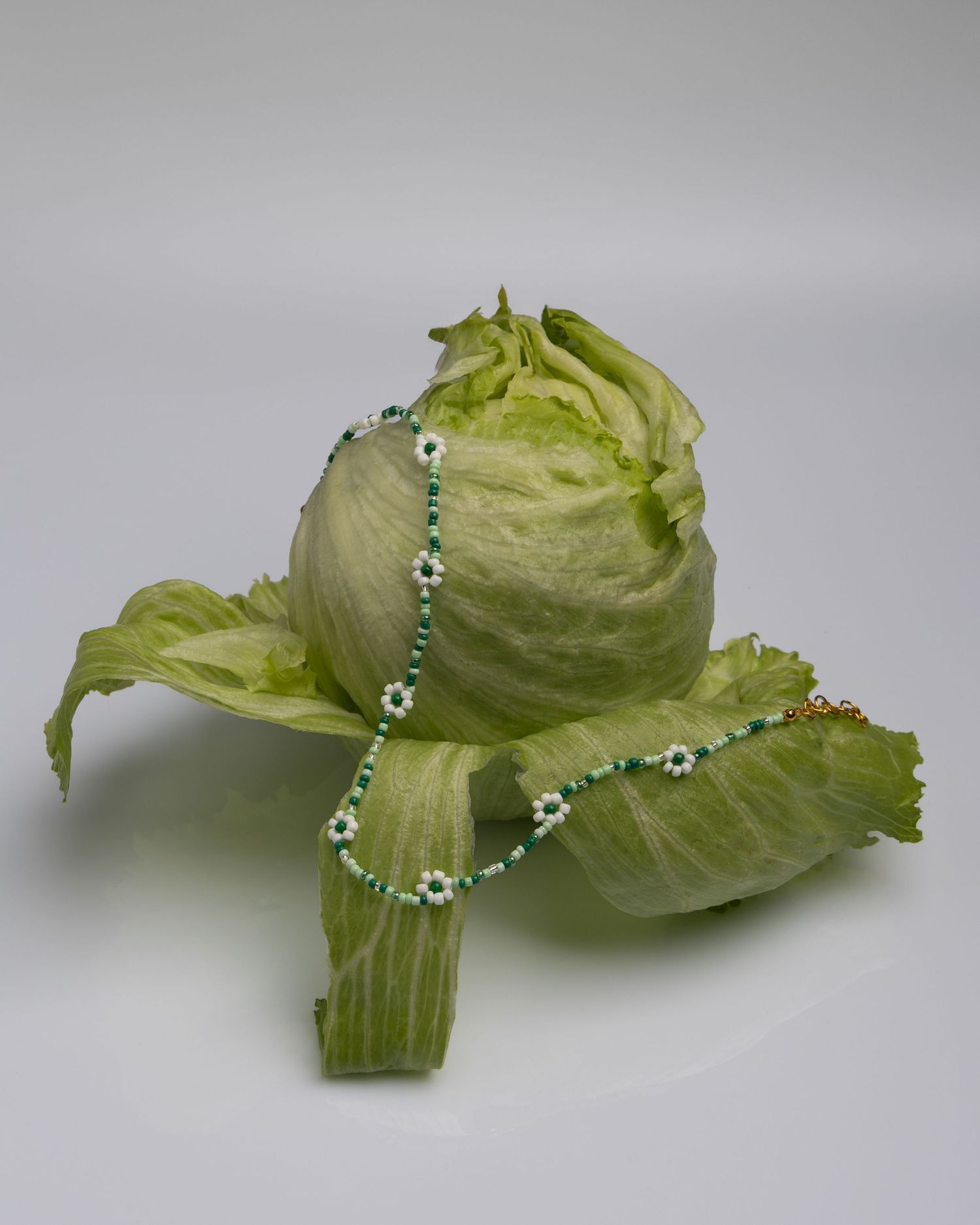 A series of macro shots showing water droplets and dew clinging to the edges of light green lettuce leaves.