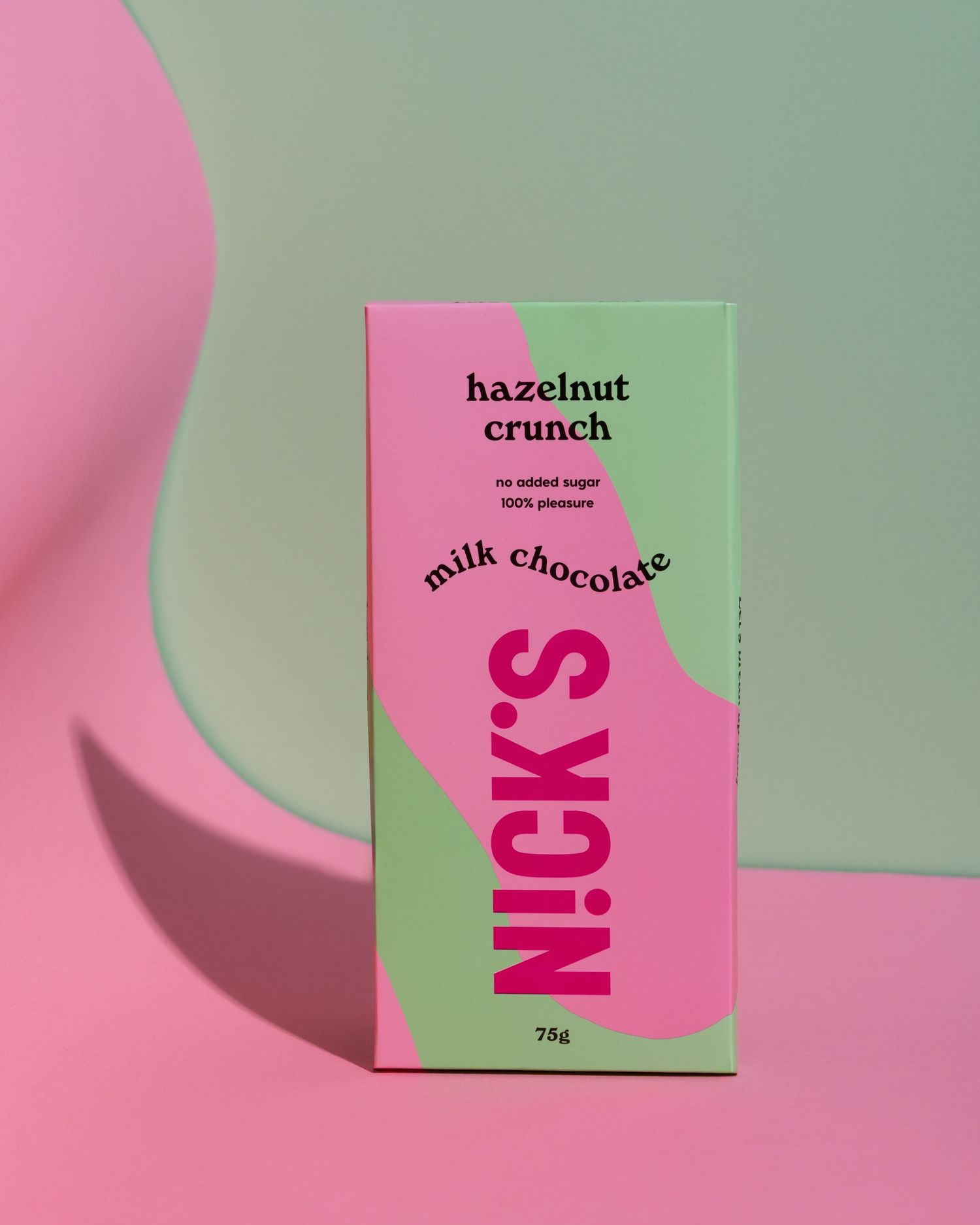 Pink and green minimalist chocolate bar packaging design shown against a two-toned pastel background.
