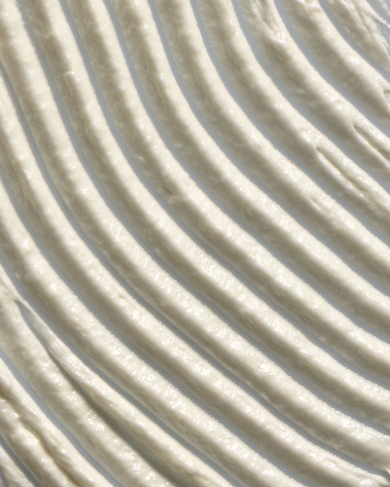 Abstract background pattern of curved white parallel lines creating a rippled geometric texture effect.