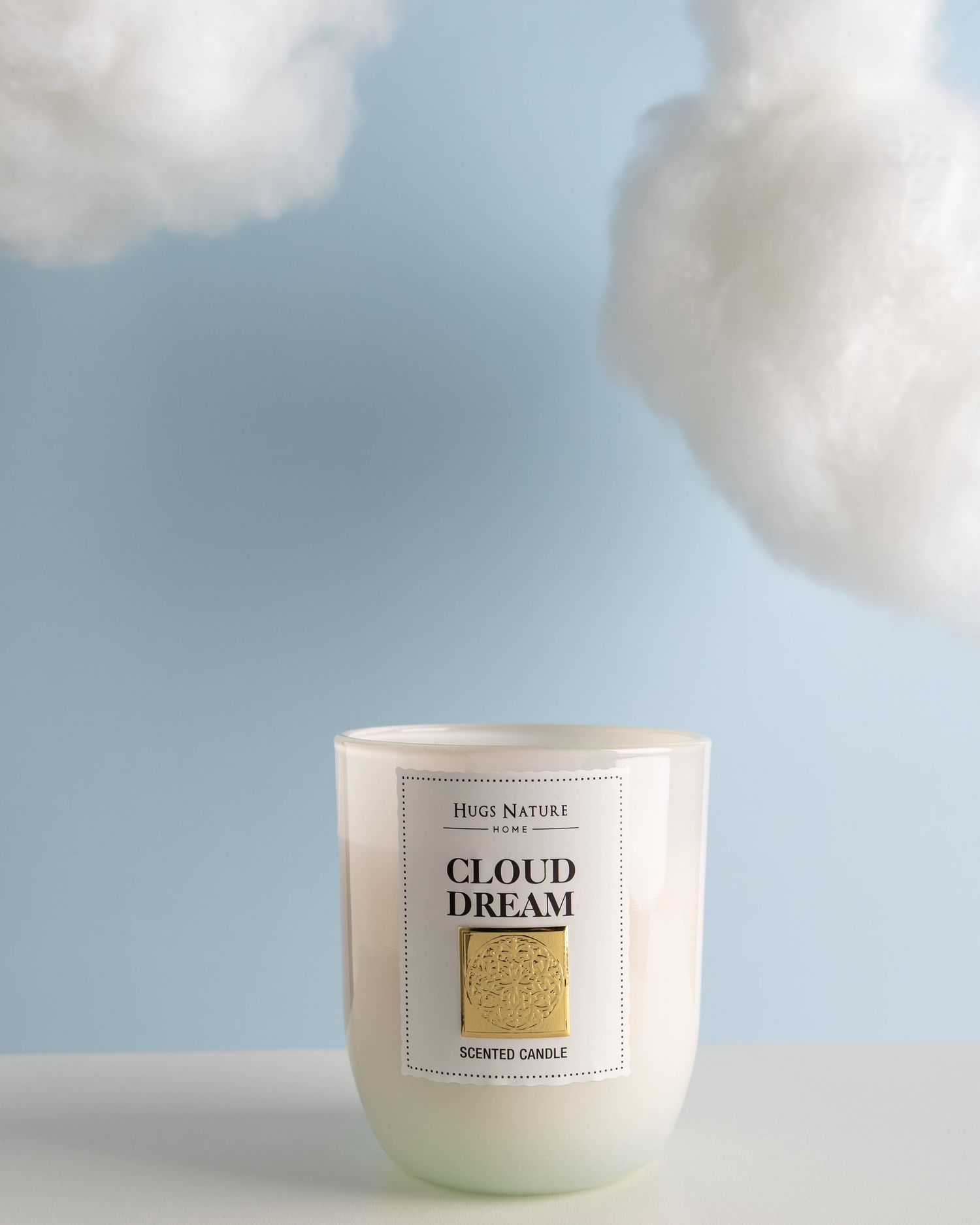 A series of white scented candles in glass jars with minimalist labels against a dreamy cloudy sky background.