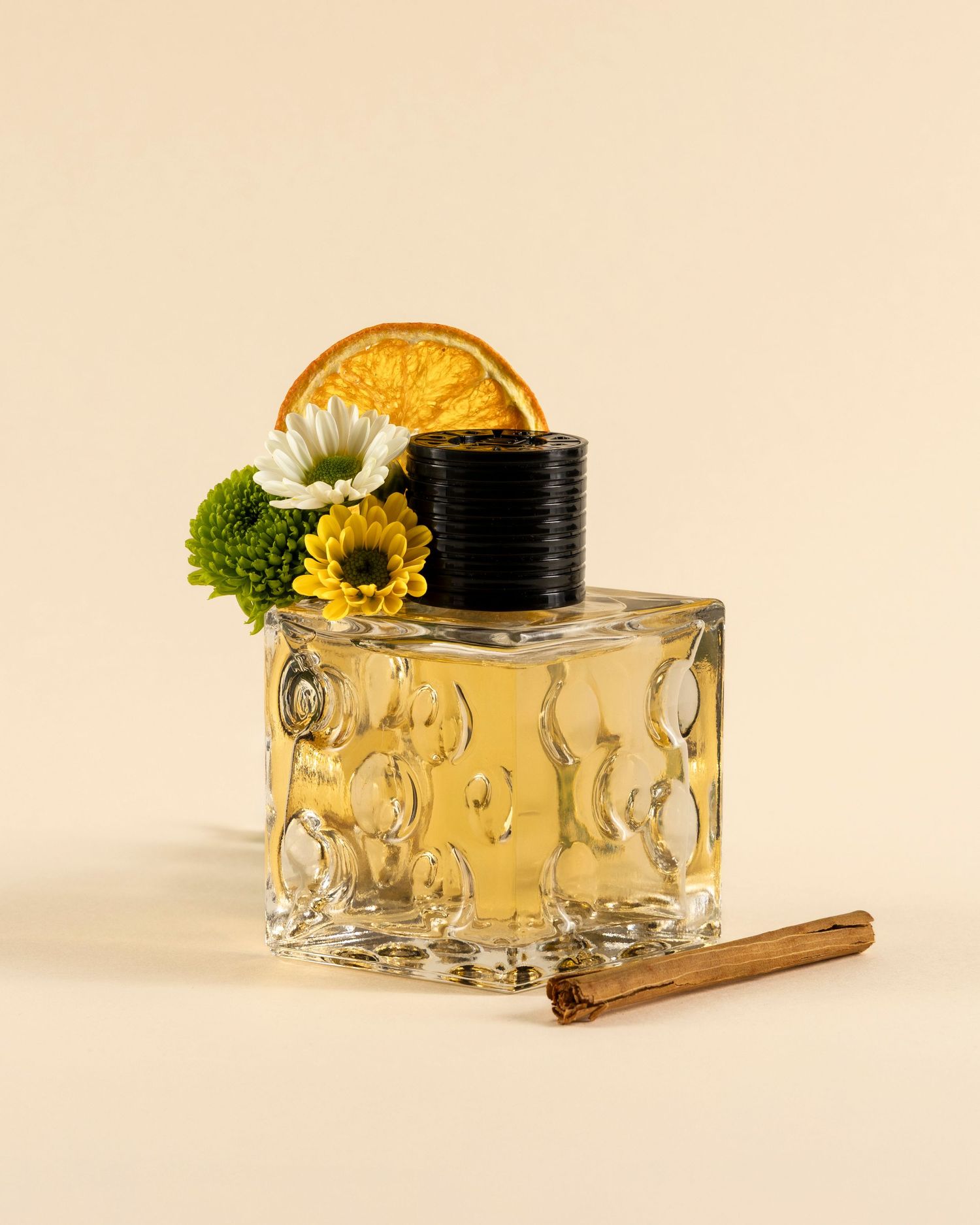 A glass jar with yellow flowers and greenery is displayed in a sequence showing different angles on a beige background.