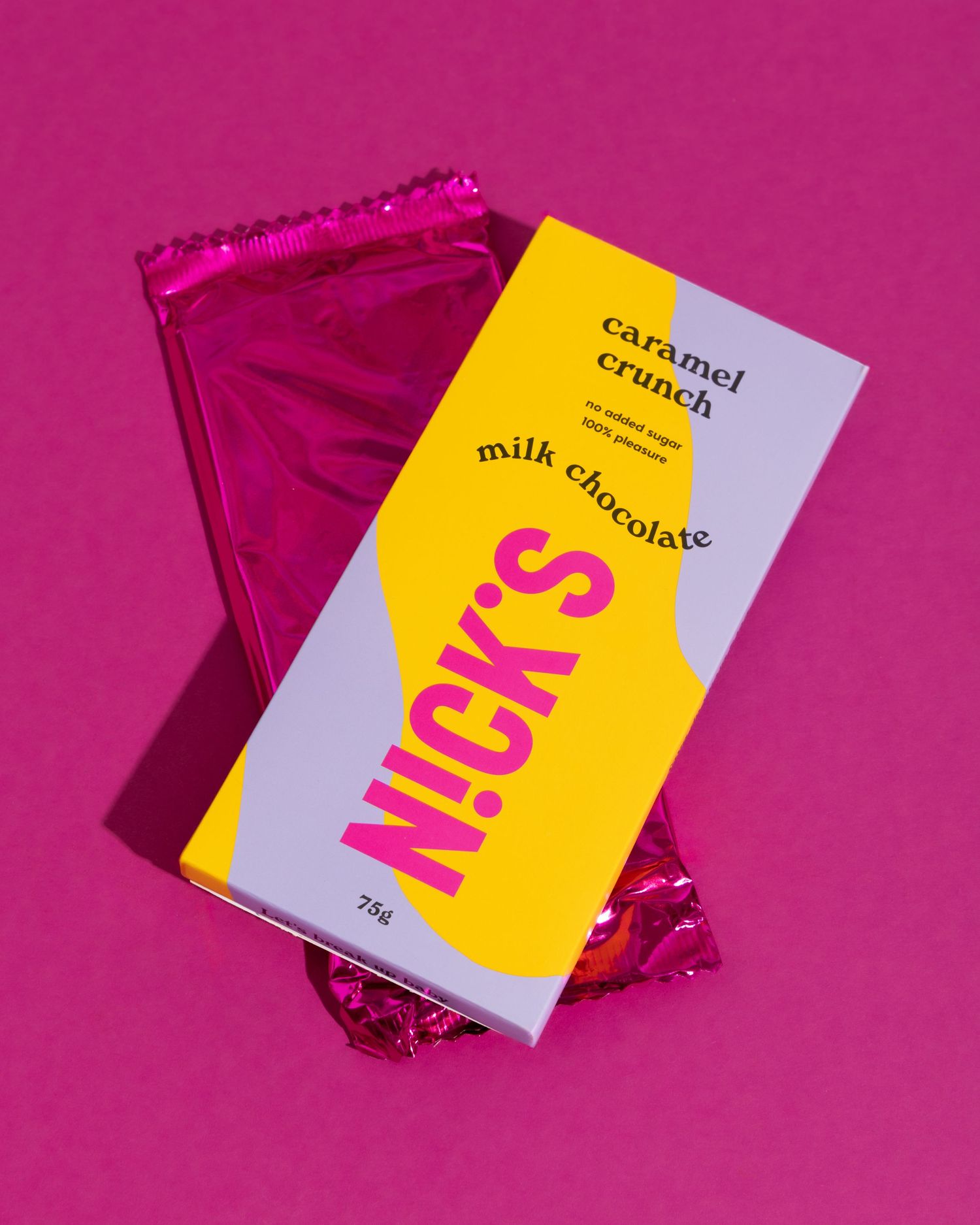 Premium chocolate packaging shot with a sleek gold and pink design on a bright magenta background.