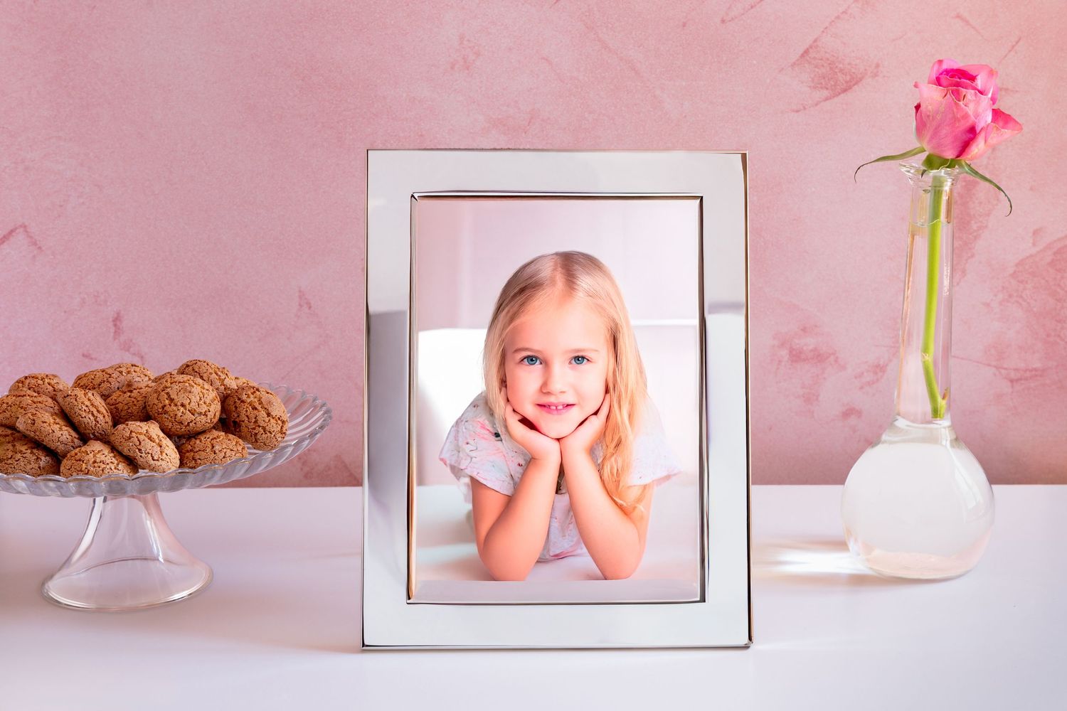 Delicate pink and white floral border design with rose petals and picture frames creating a romantic decorative pattern.