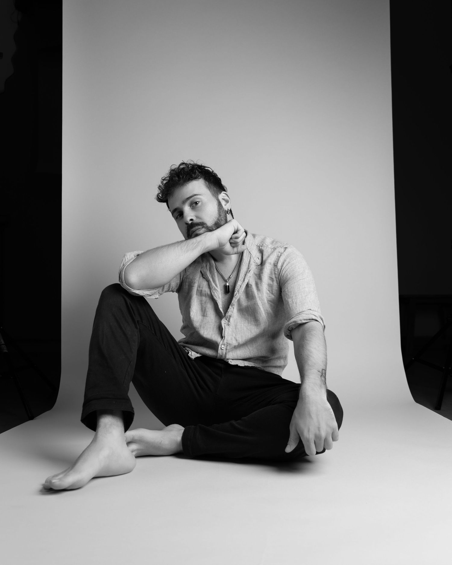 Dramatic black and white photo series showing artistic poses on a white backdrop.
