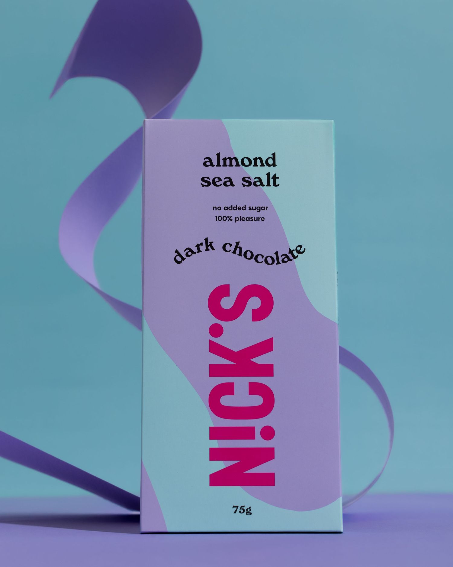 Nick's chocolate bar packaging with purple ribbon decoration against turquoise background in studio lighting.