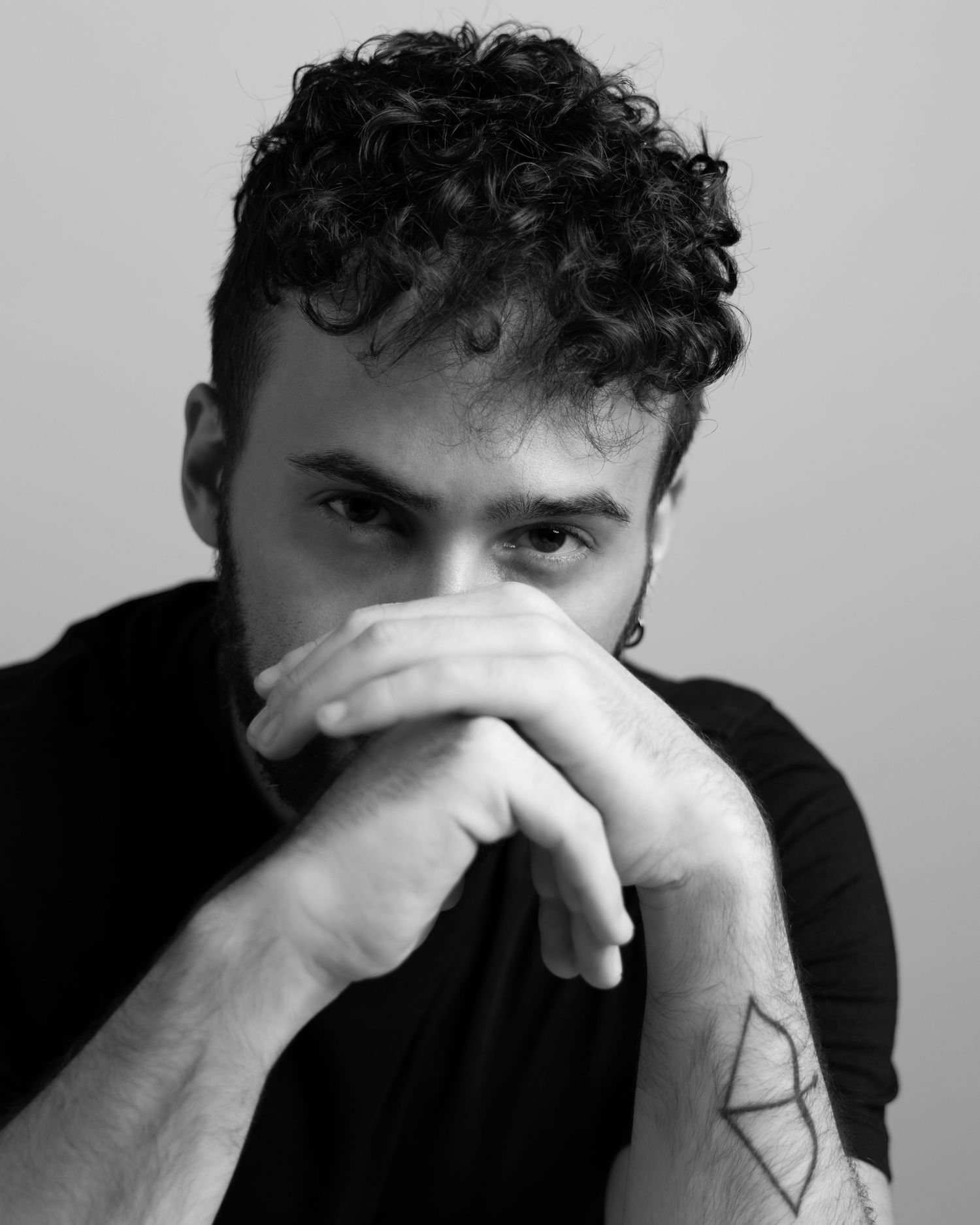 A series of black and white photos showing a person covering their face with their hands in distress.