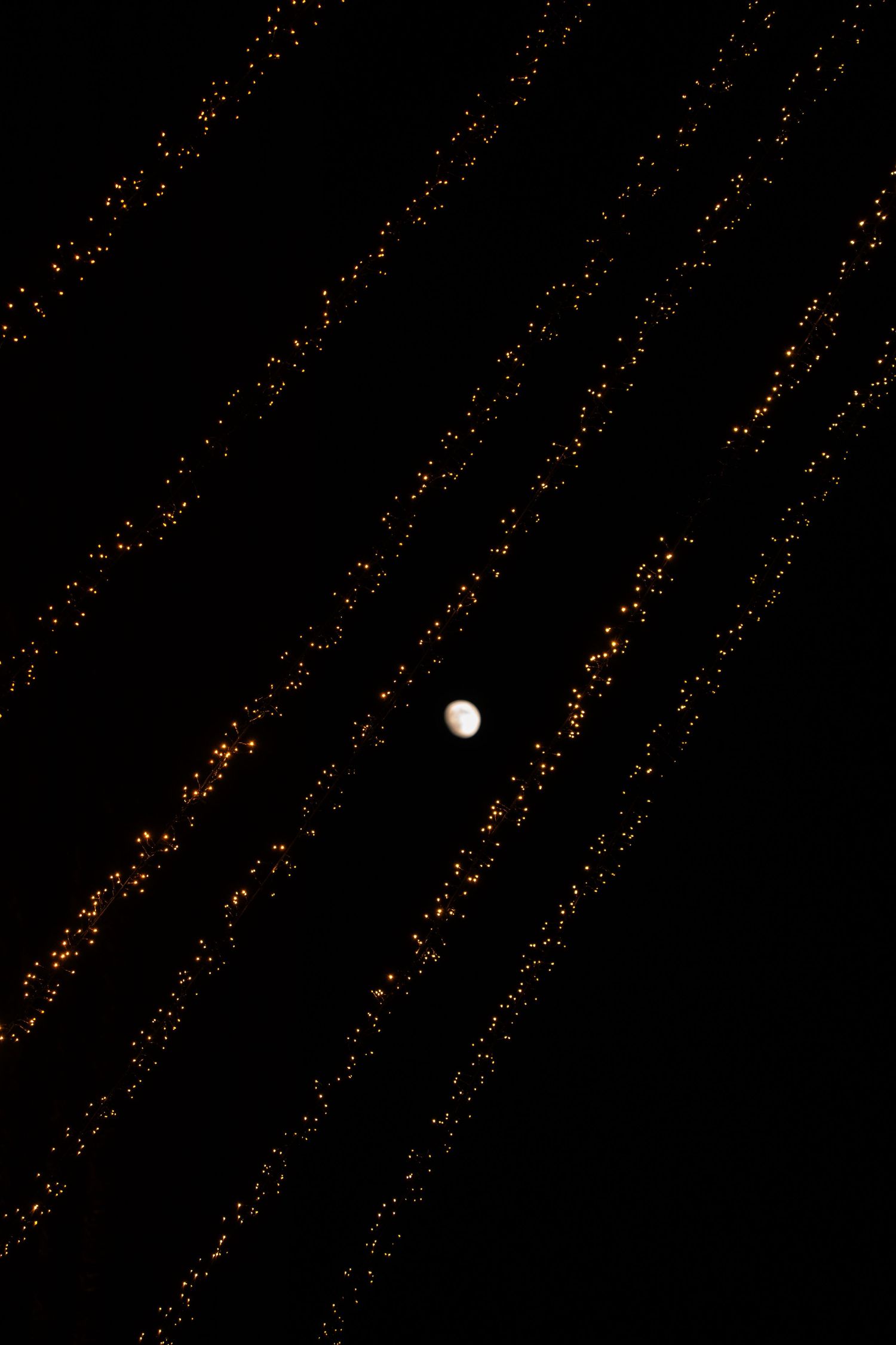 moon with string lights, Battersea power station, London, new years eve. Tied in Time Photography.