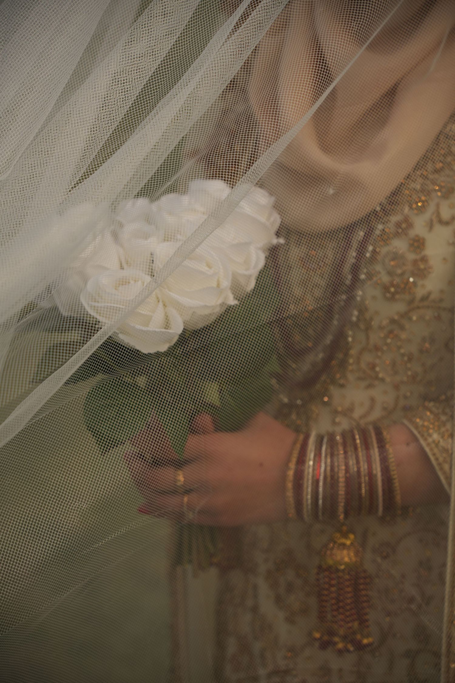 white roses and bridal details. red and gold bridal outfit. under white veil. Tied in Time Photography.