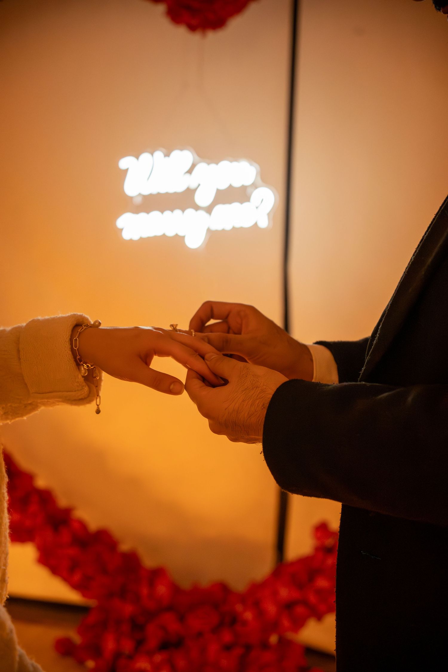groom putting ring on bride with 