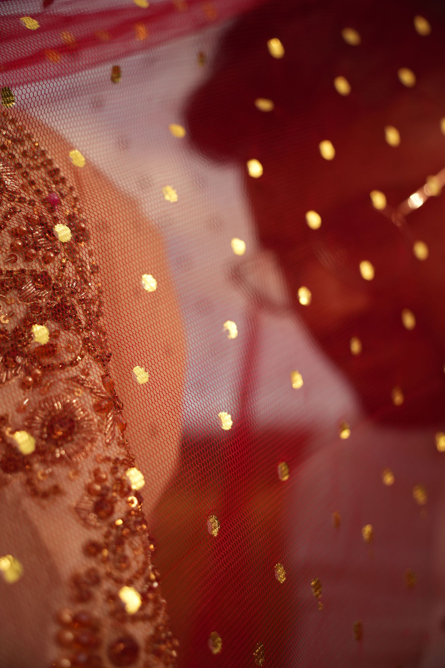 bride and groom under red veil. Tied in Time Photography.