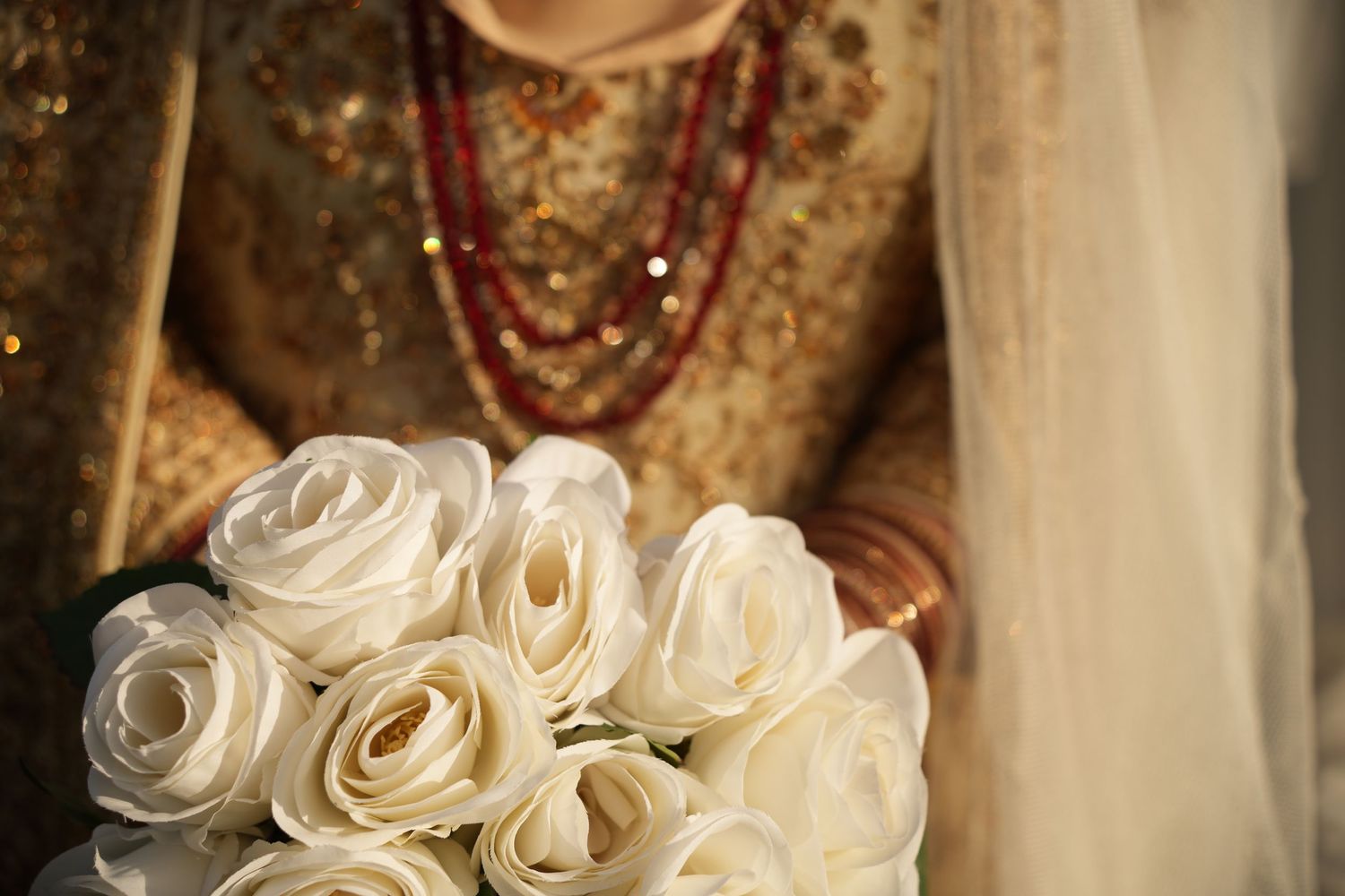 white roses and bridal details. red and gold bridal outfit. Tied in Time Photography.