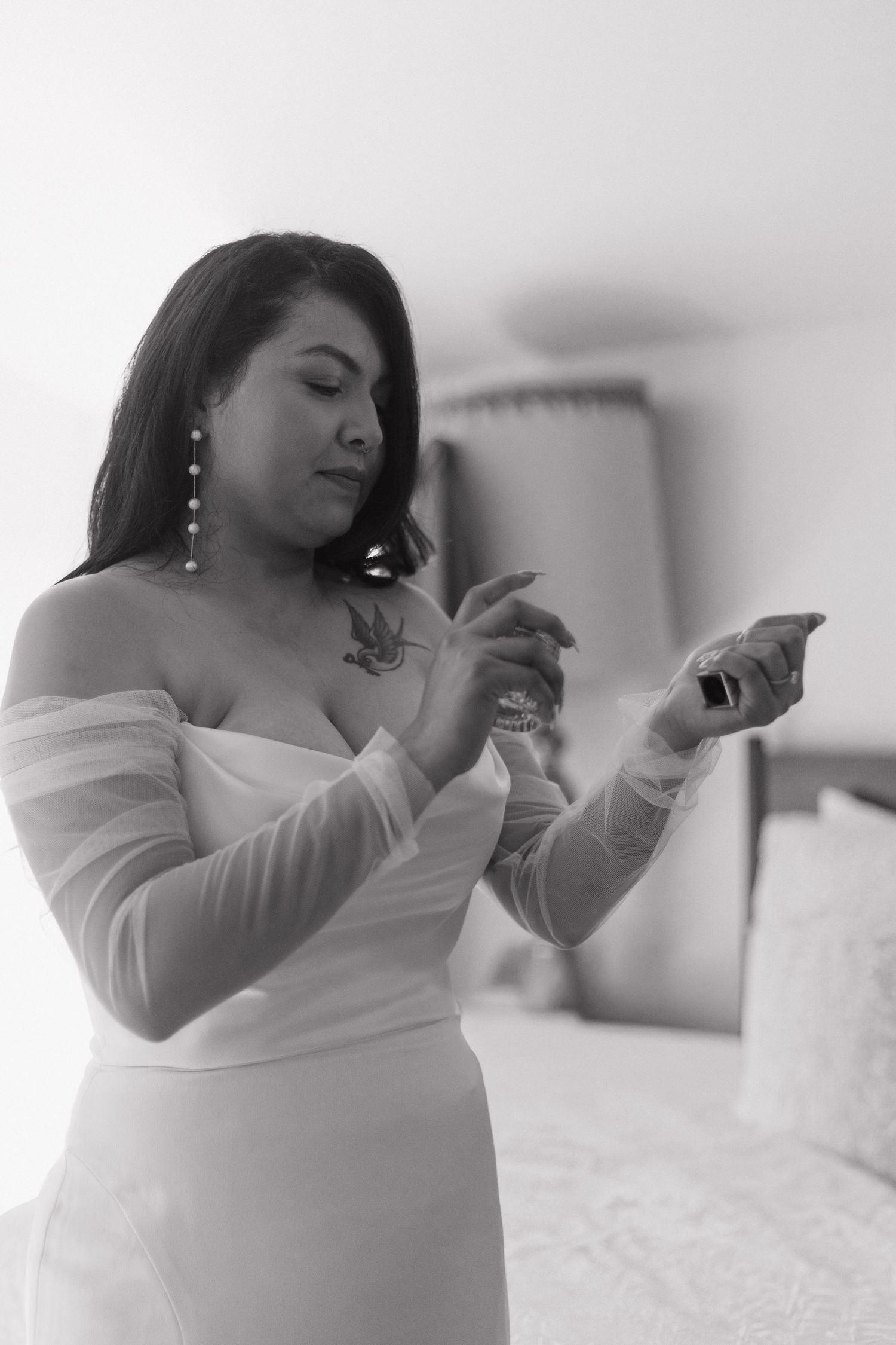 Black and white getting ready photos showing final wedding day preparations.