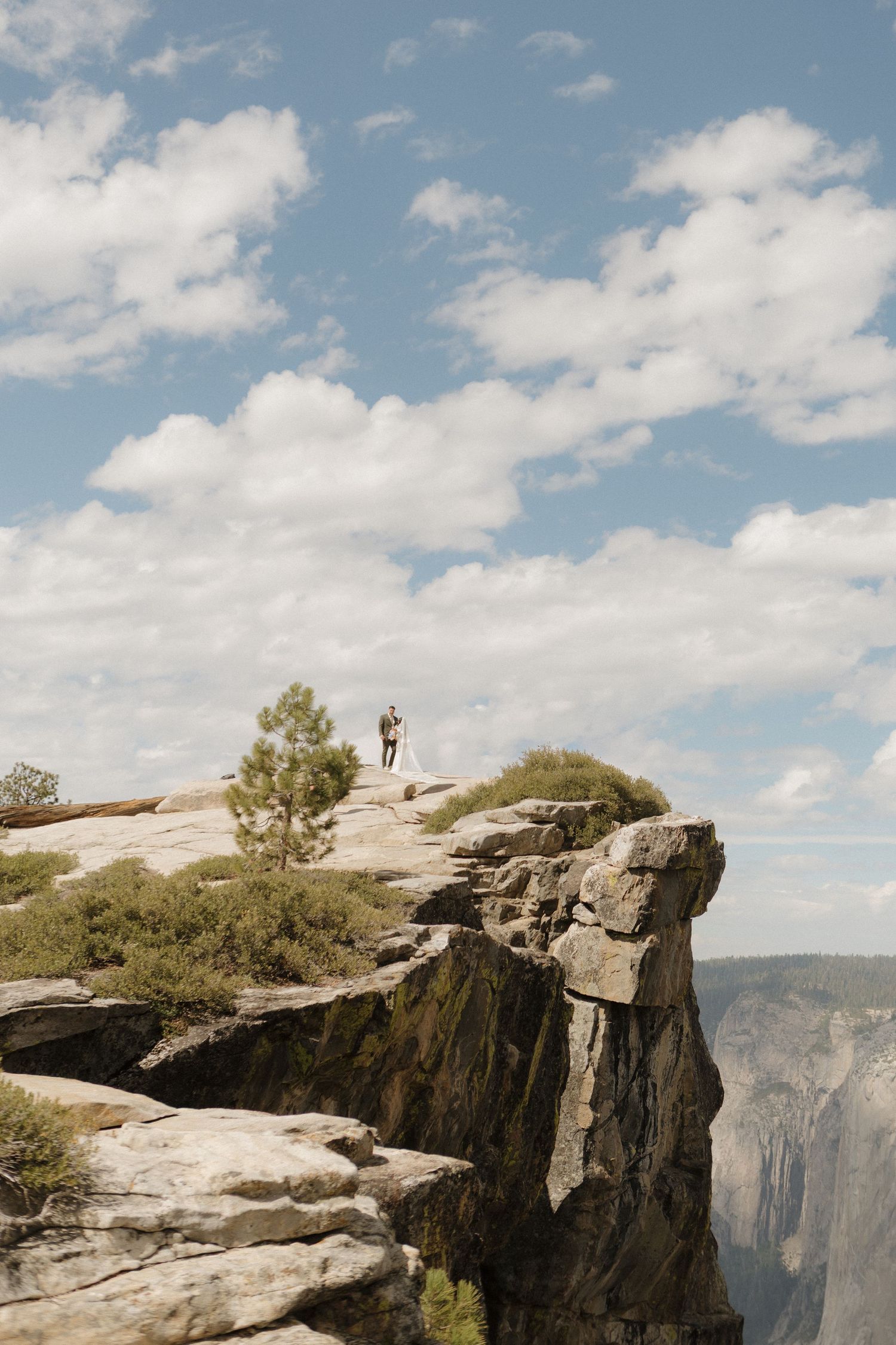 Dramatic cliffside wedding ceremony location at Yosemite's Taft Point with sweeping mountain views.