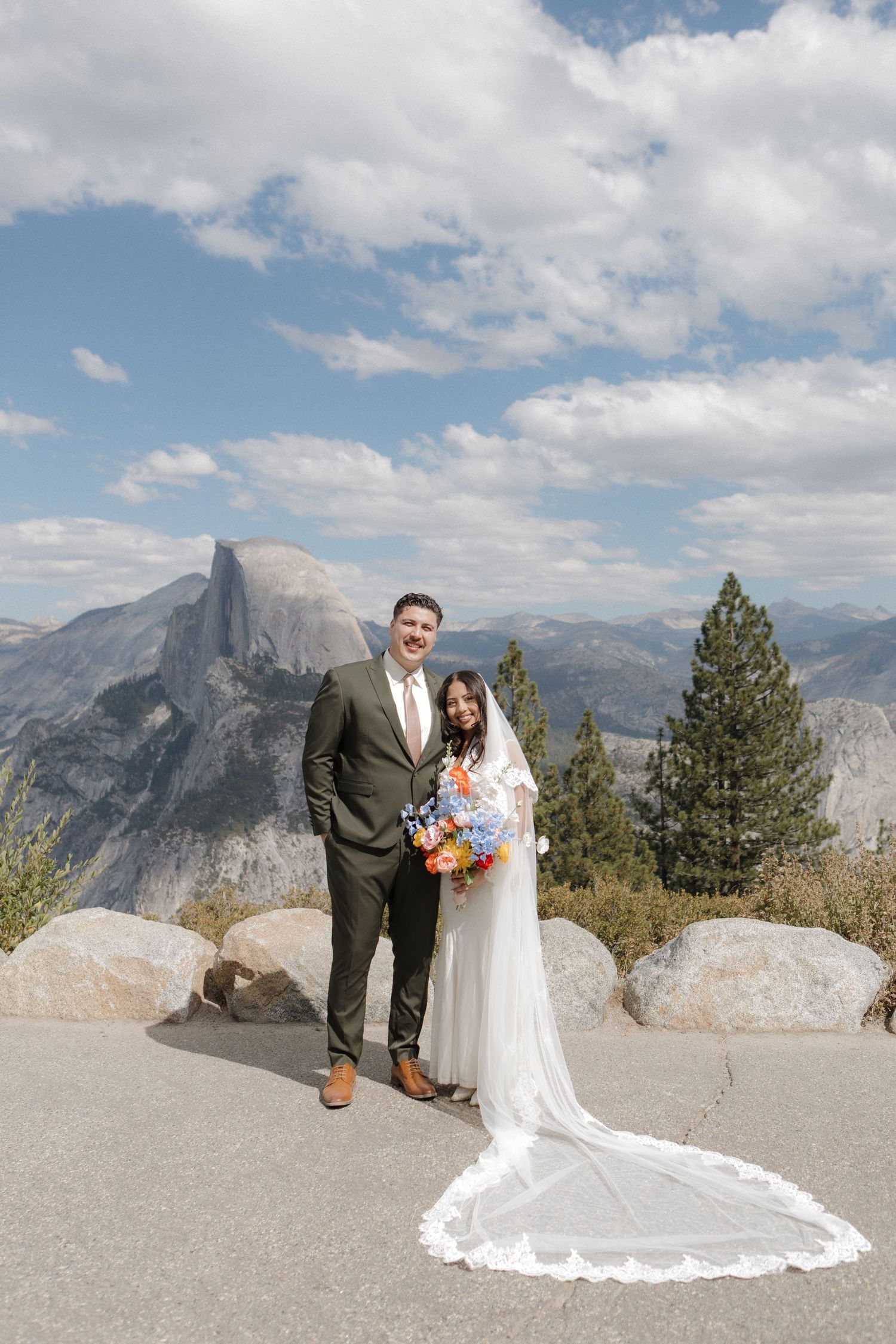 Wedding photoshoot at Yosemite's Glacier Point with Half Dome in background.