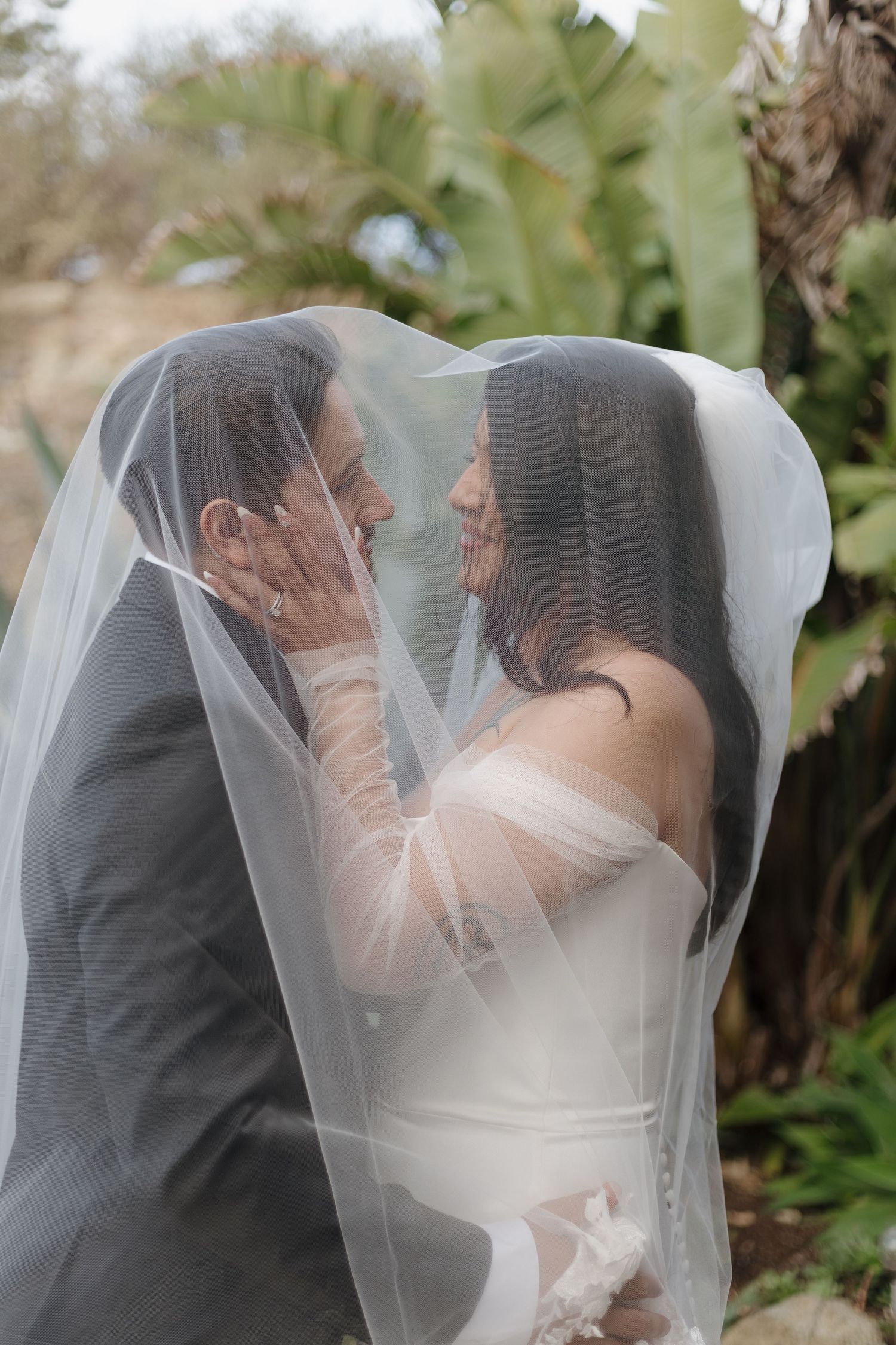 Romantic veil portraits capturing intimate moments between the newlyweds.