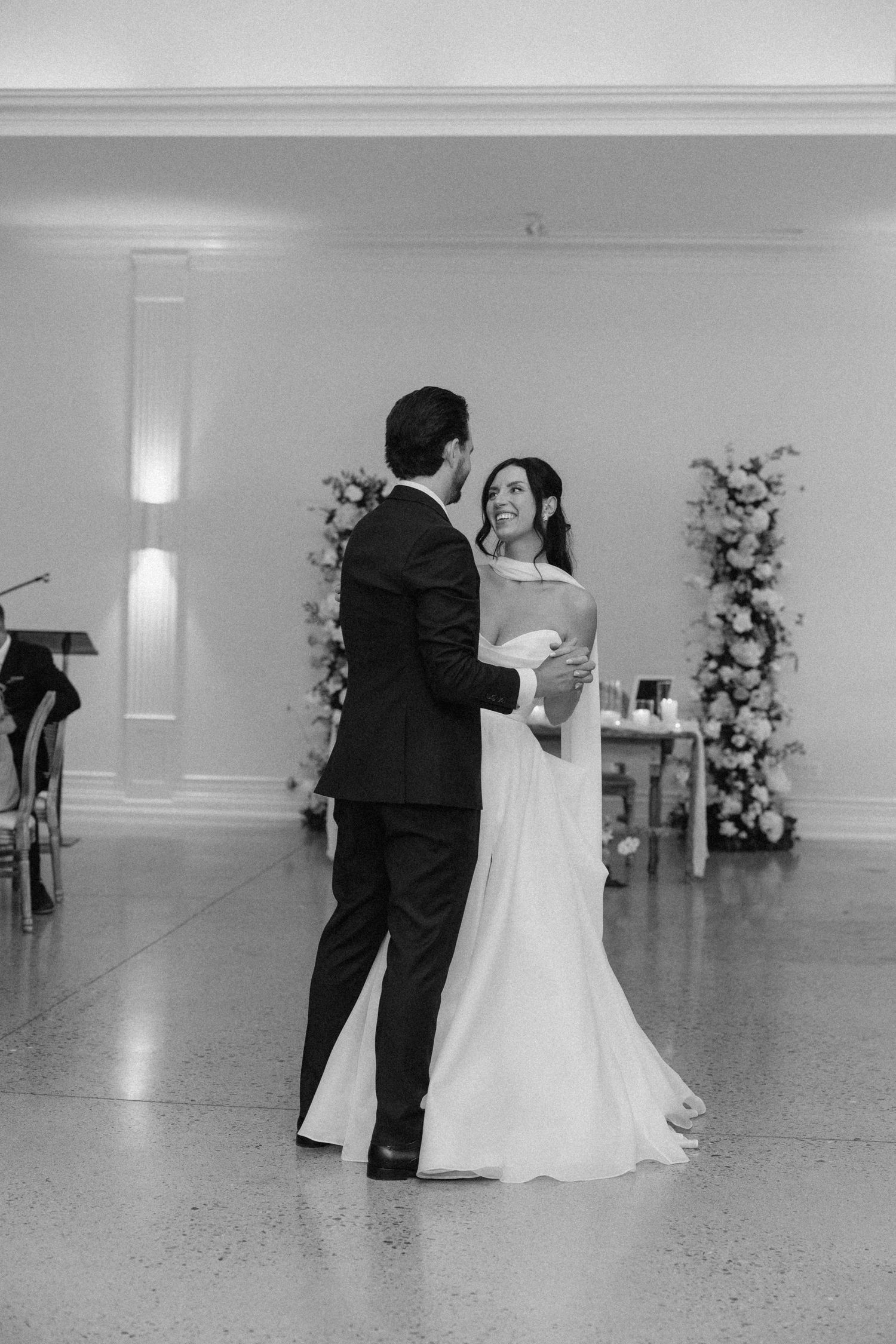 Black and white photo of bride and groom sharing their first dance at Roseville Estates wedding reception.