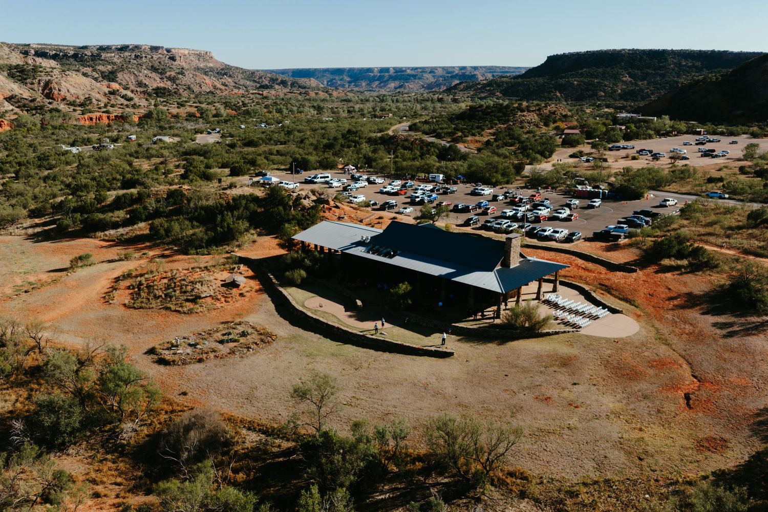 Panoramic desert landscape view of wedding venue nestled among rocky mountains.