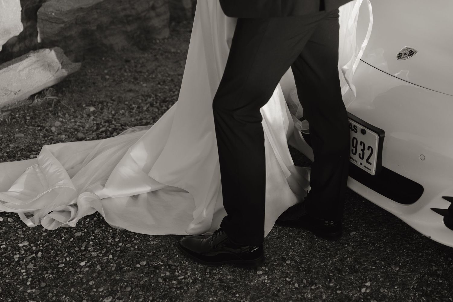 Wedding couple's romantic interactions captured in artistic black and white low angles.
