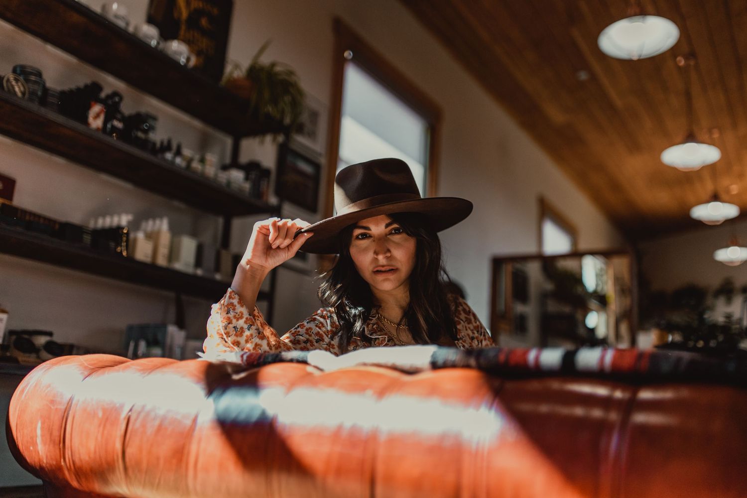 Candid lifestyle photos on orange couch showing relaxed indoor moments.