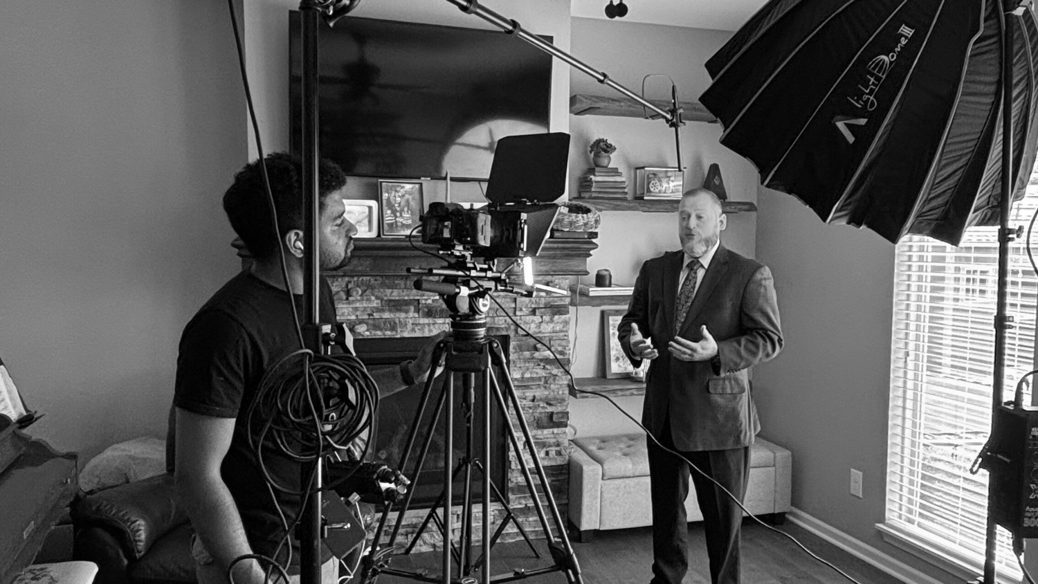 Behind-the-scenes photo shoot setup with lighting equipment and photography gear in a studio setting.