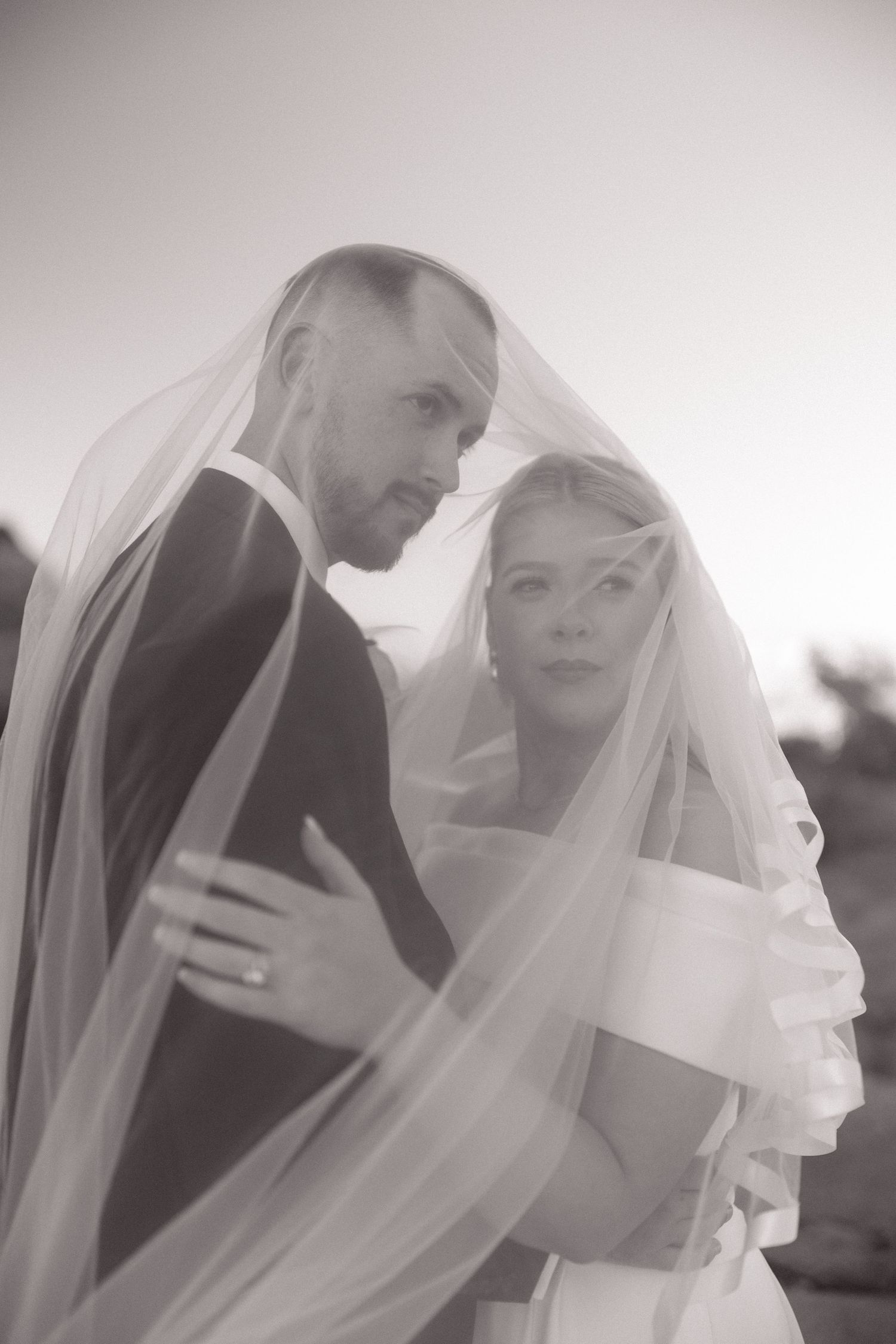 Romantic black and white sequence of a couple sharing intimate moments under a wedding veil.