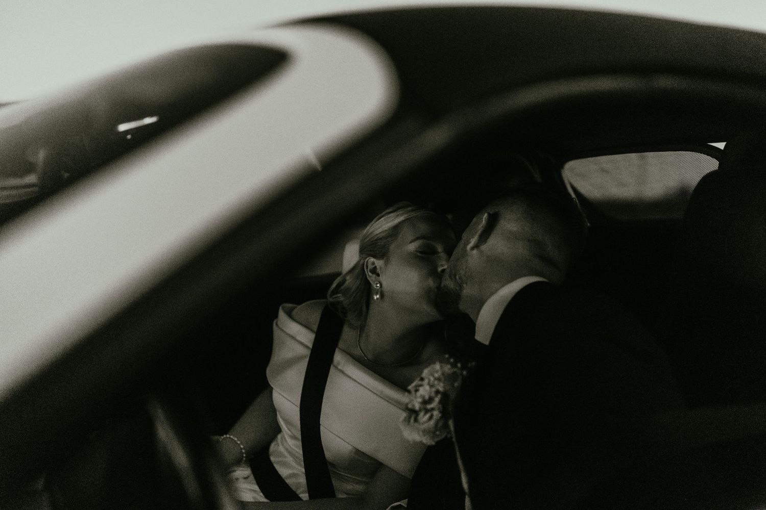 A romantic wedding photo sequence showing intimate moments between a couple through a car window.
