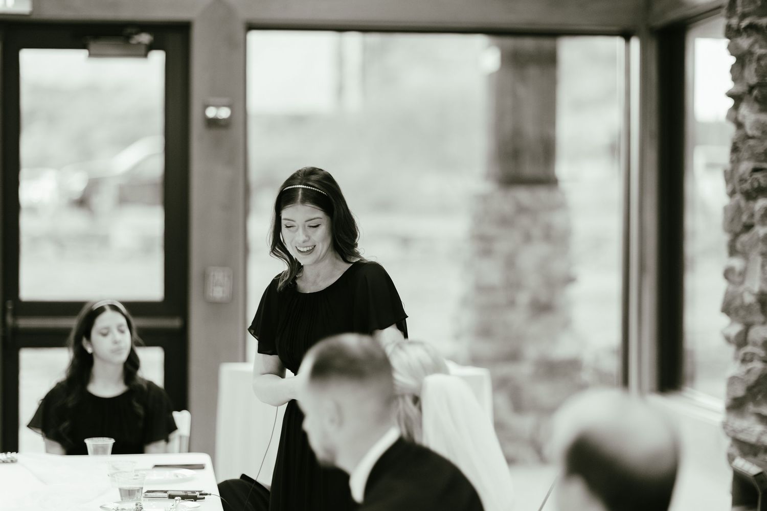 Wedding celebration candids showing joyful moments in an indoor venue.