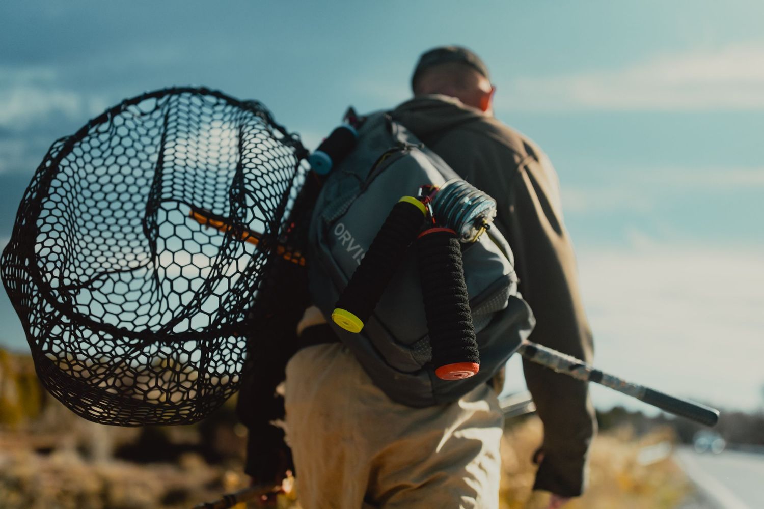 Adventure gear and equipment laid out against a dramatic outdoor landscape.