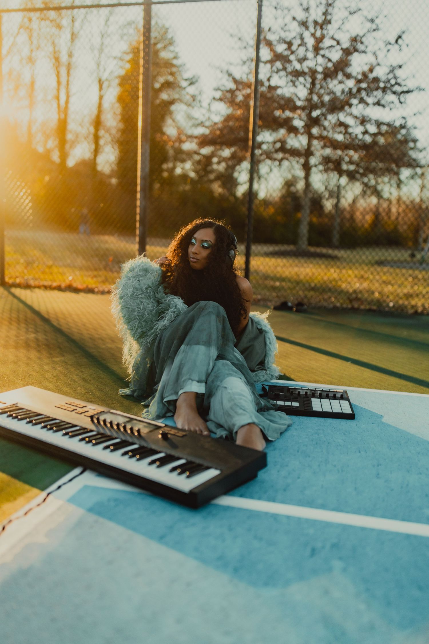 Artistic sunset photos of someone playing keyboard instruments outdoors with golden light.