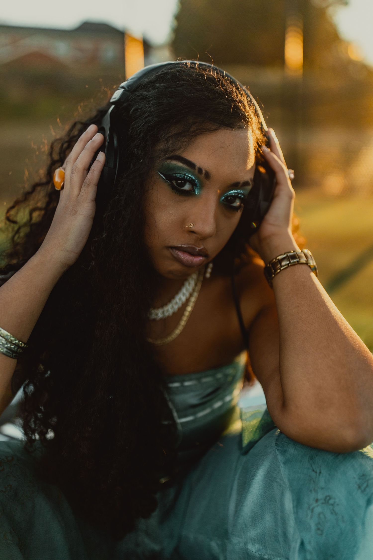 Sunset portrait session with dramatic golden hour lighting and pearl accessories.