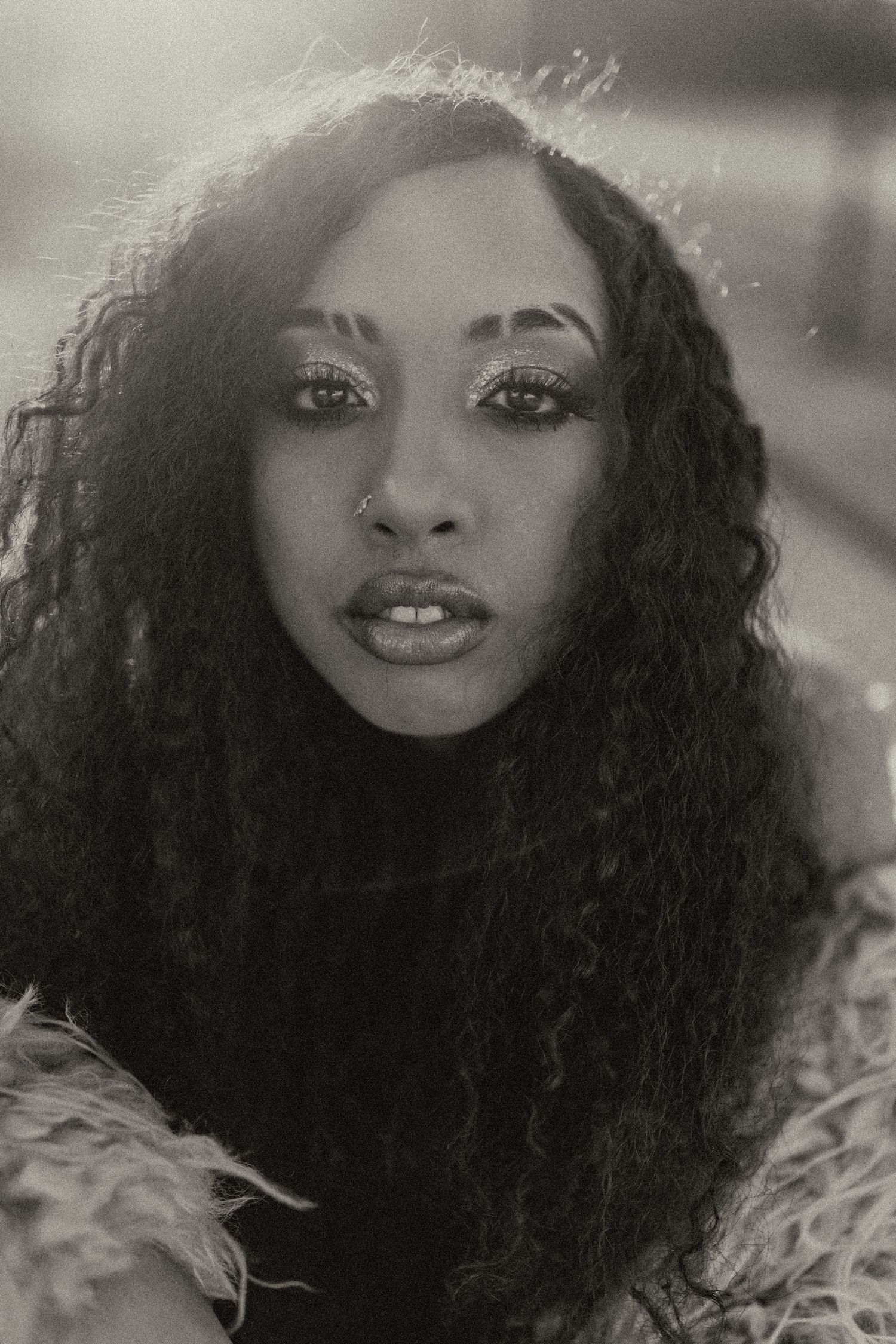 Artistic black and white portraits showing glamorous curly hair and expressive features.
