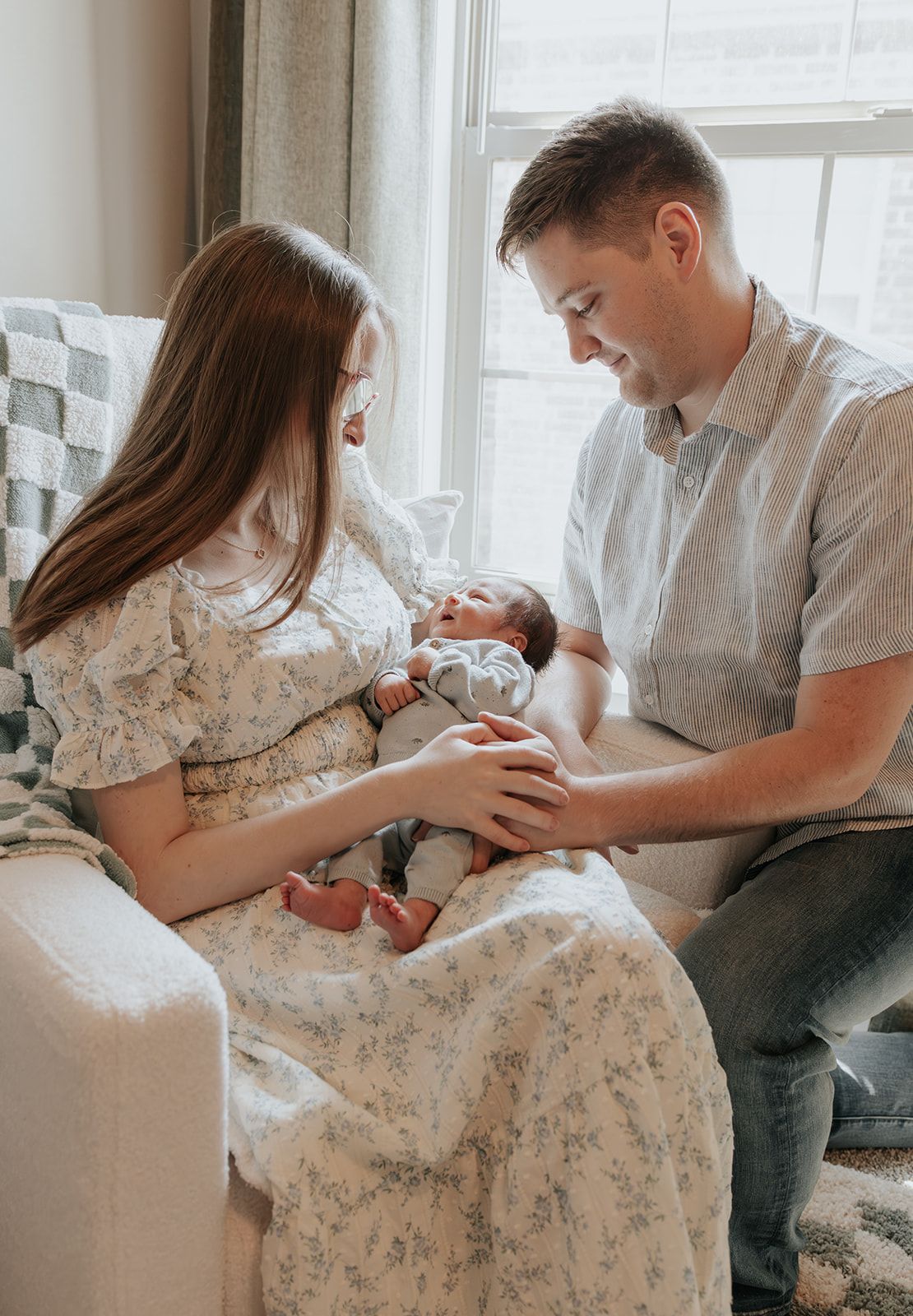 Parents and newborn baby boy in nursery during in-home newborn photoshoot in Springfield, Missouri