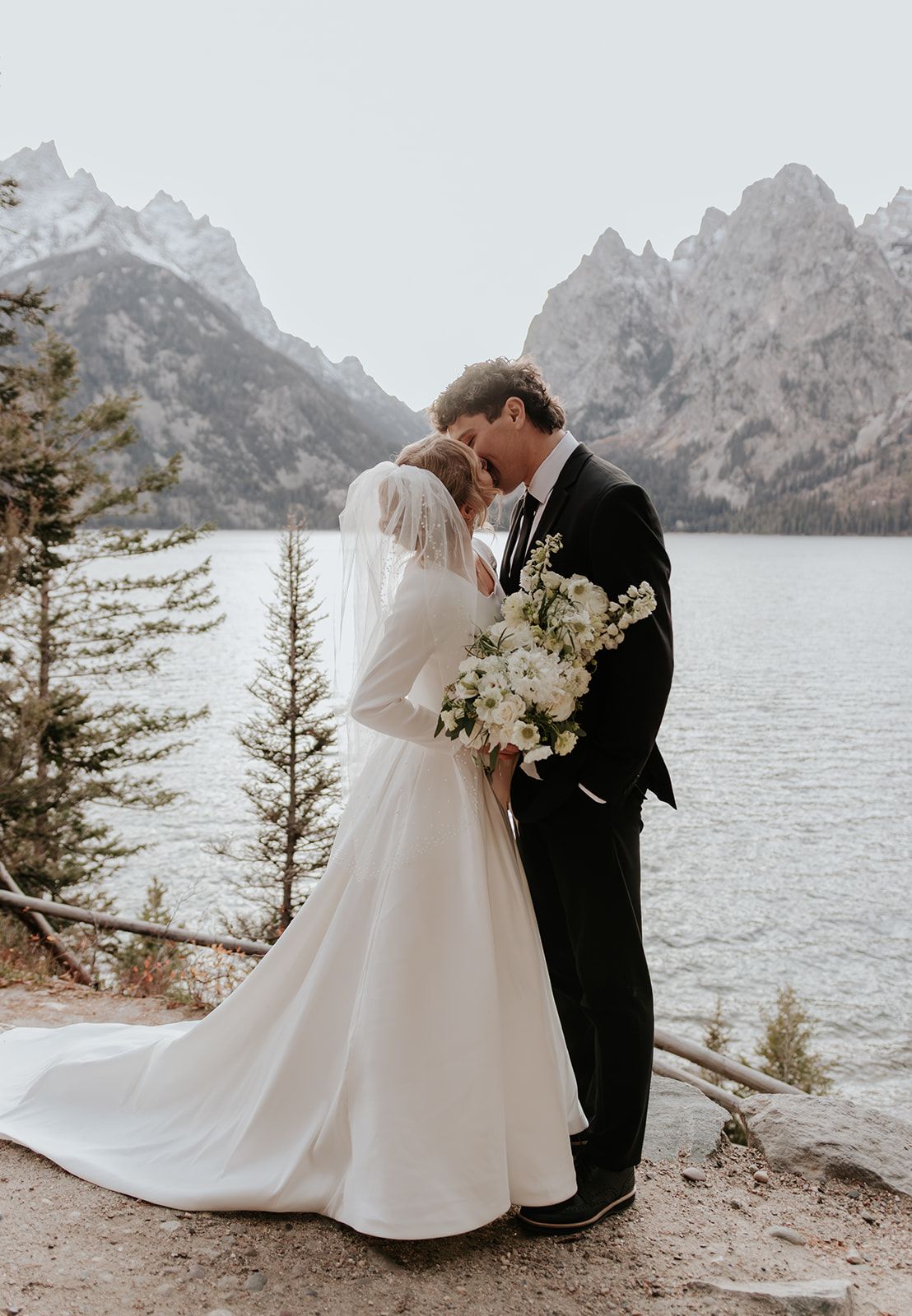 Photo of bride and groom at Jenny Lake in Grand Teton National Park at sunset. Bridal photos in the Tetons