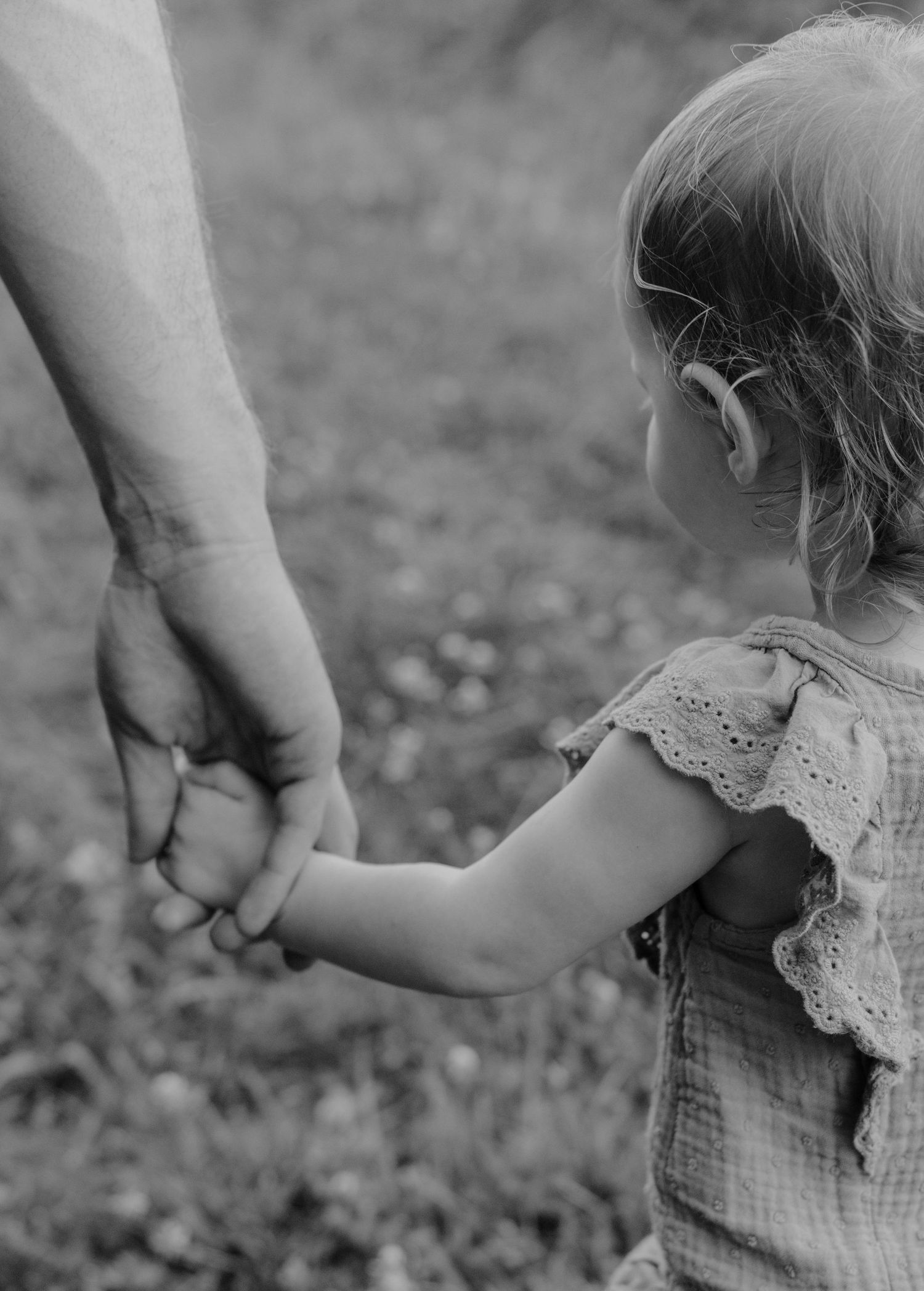 Father and daughter holding hands and walking, candid family photos at Wilson's Creek National Battlefield in Springfield, Missouri