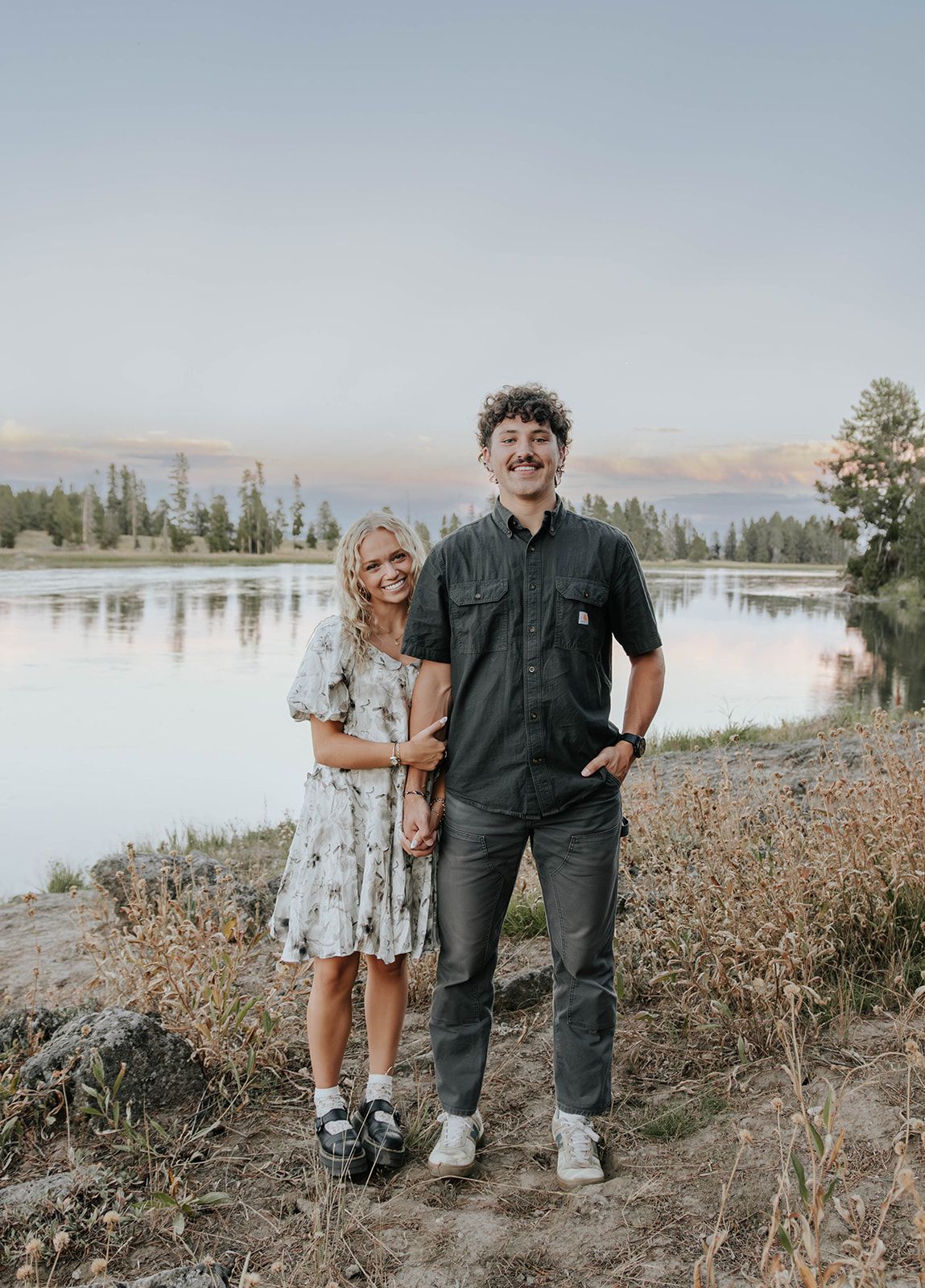 Couples engagement session at Harriman State Park in Island Park, Idaho by the lake in August at sunset