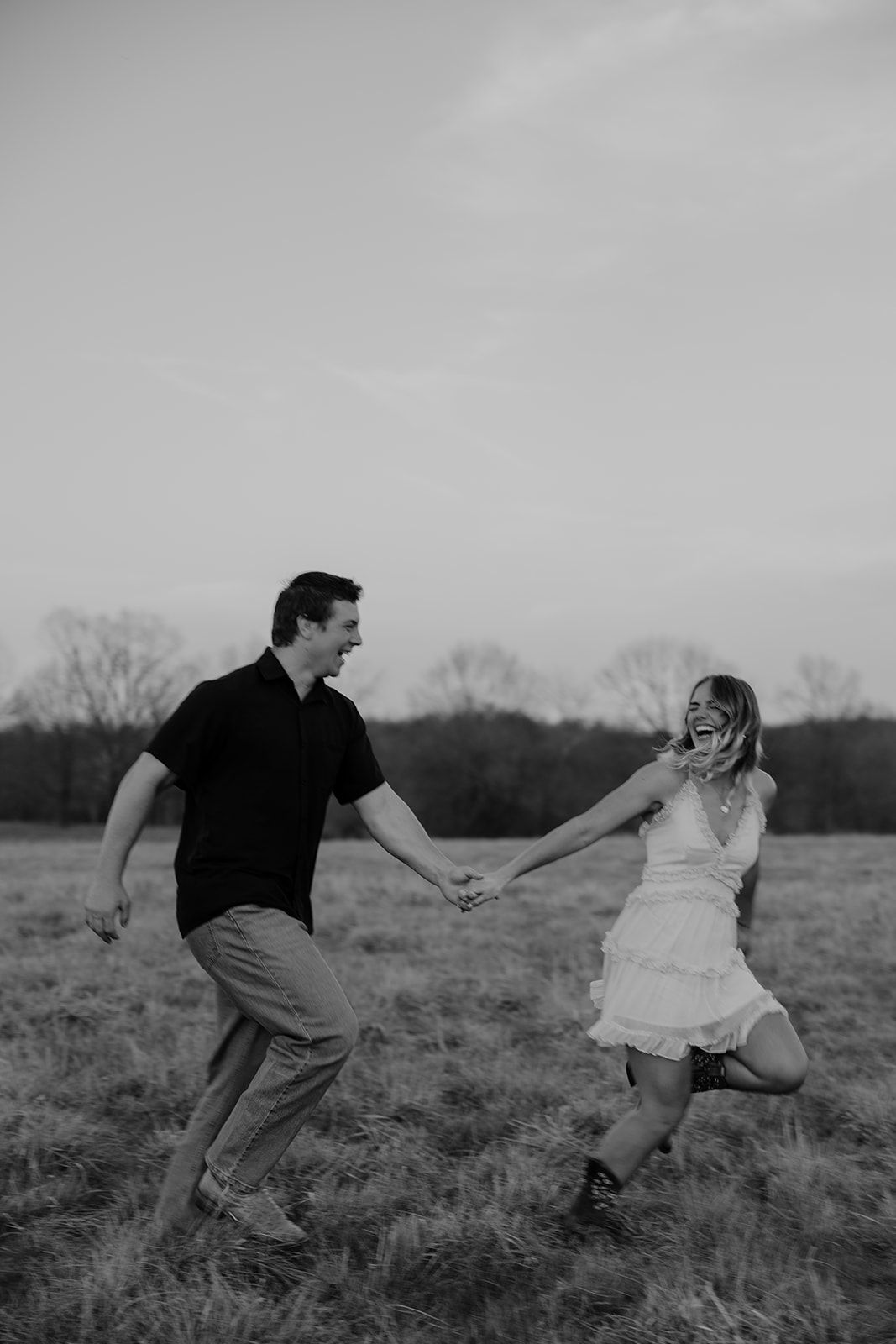 Photo of a couple running through a field