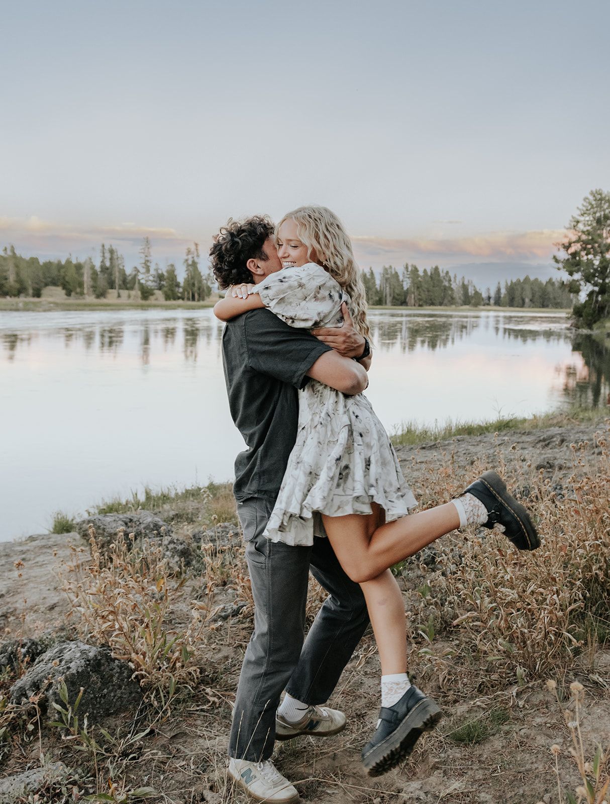 Couples engagement session at Harriman State Park in Island Park, Idaho by the lake in August at sunset. Candid couples photo