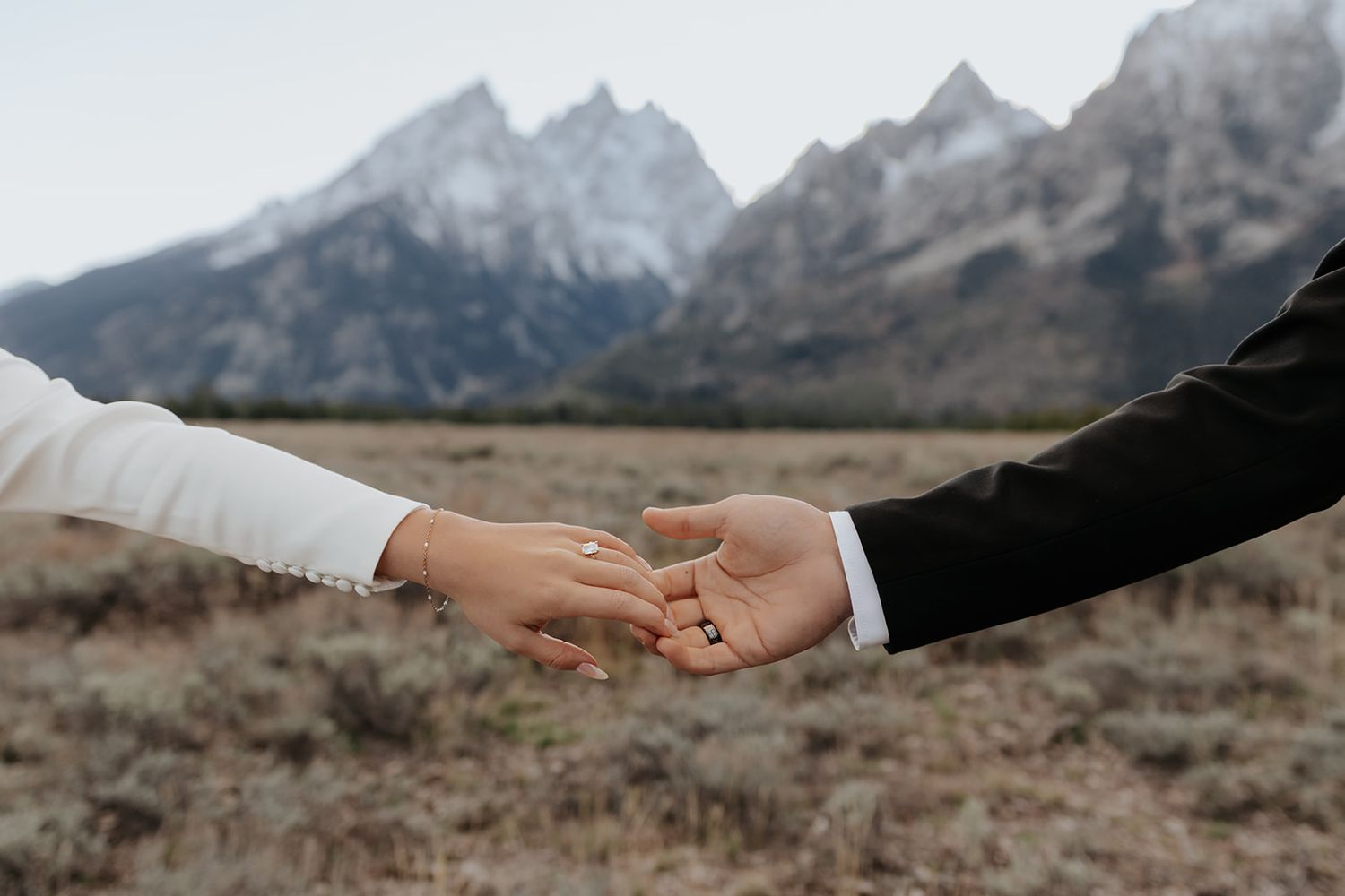 Couples hands touching during wedding photos in Grand Teton National Park near Jackson Hole, Wyoming